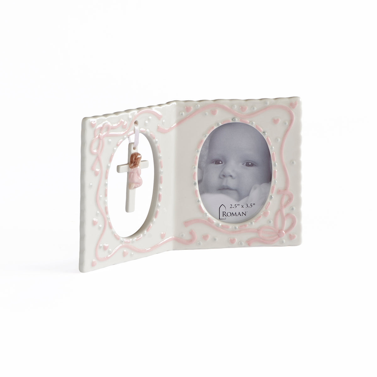 Front angled view of pink Hanging Cross & Praying Child Keepsake Picture Frame showing the baby photo opening and praying child with cross