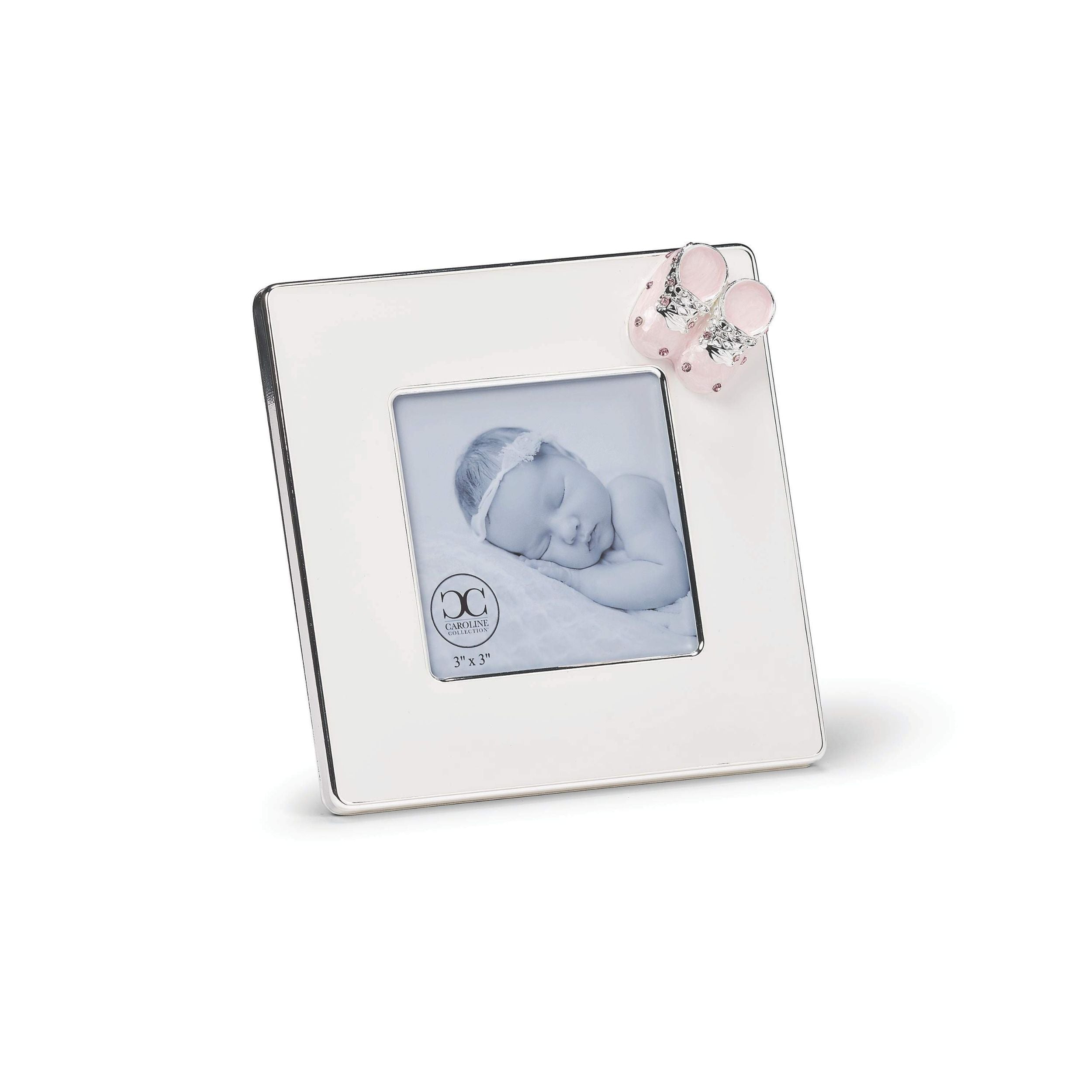 Silver photo frame with a pink baby shoe on a white background