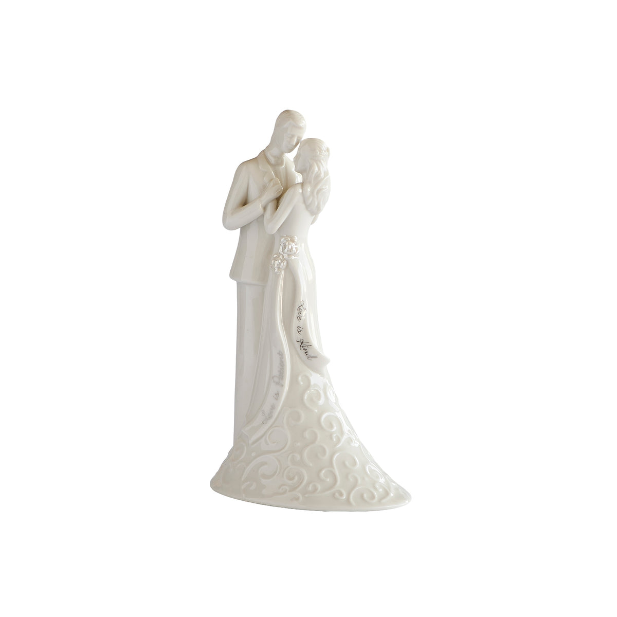 Angled front view of wedding cake topper showing the couple’s embrace and the bride’s flared, patterned gown.