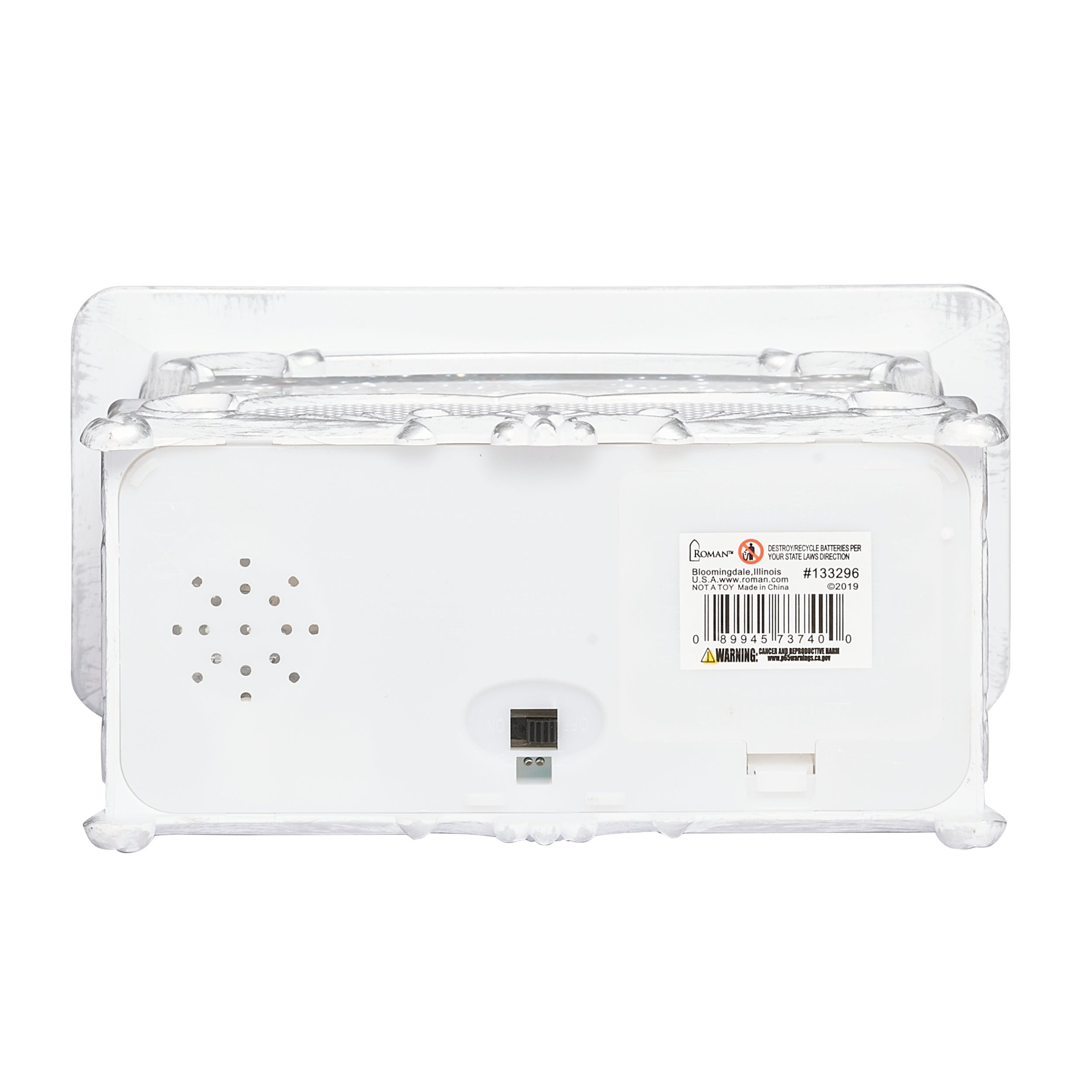 The back view of a white electronic device  showing a barcode label and speaker holes on a white background.