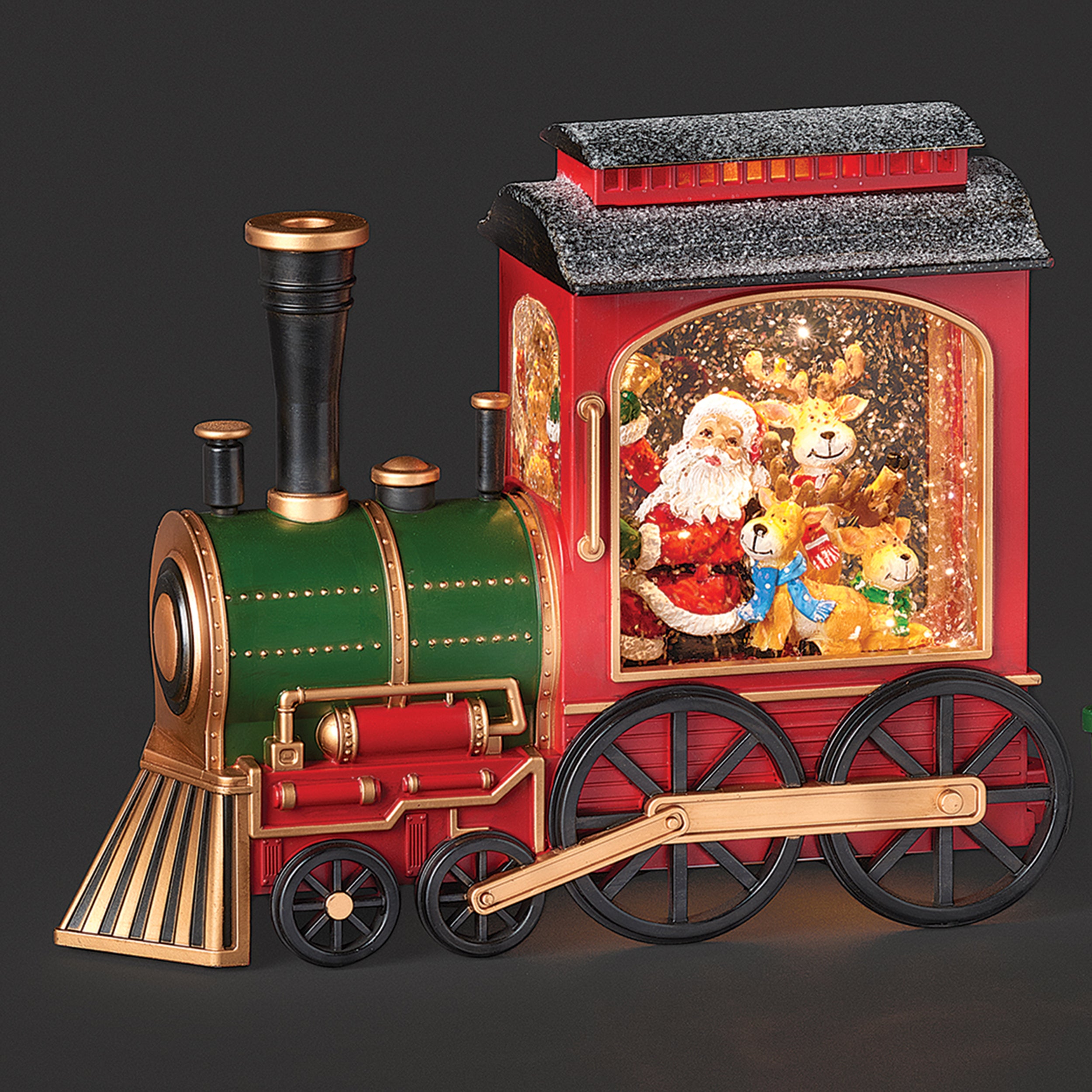Decorative train with a Santa Claus figure and reindeer inside a glass case on a dark background
