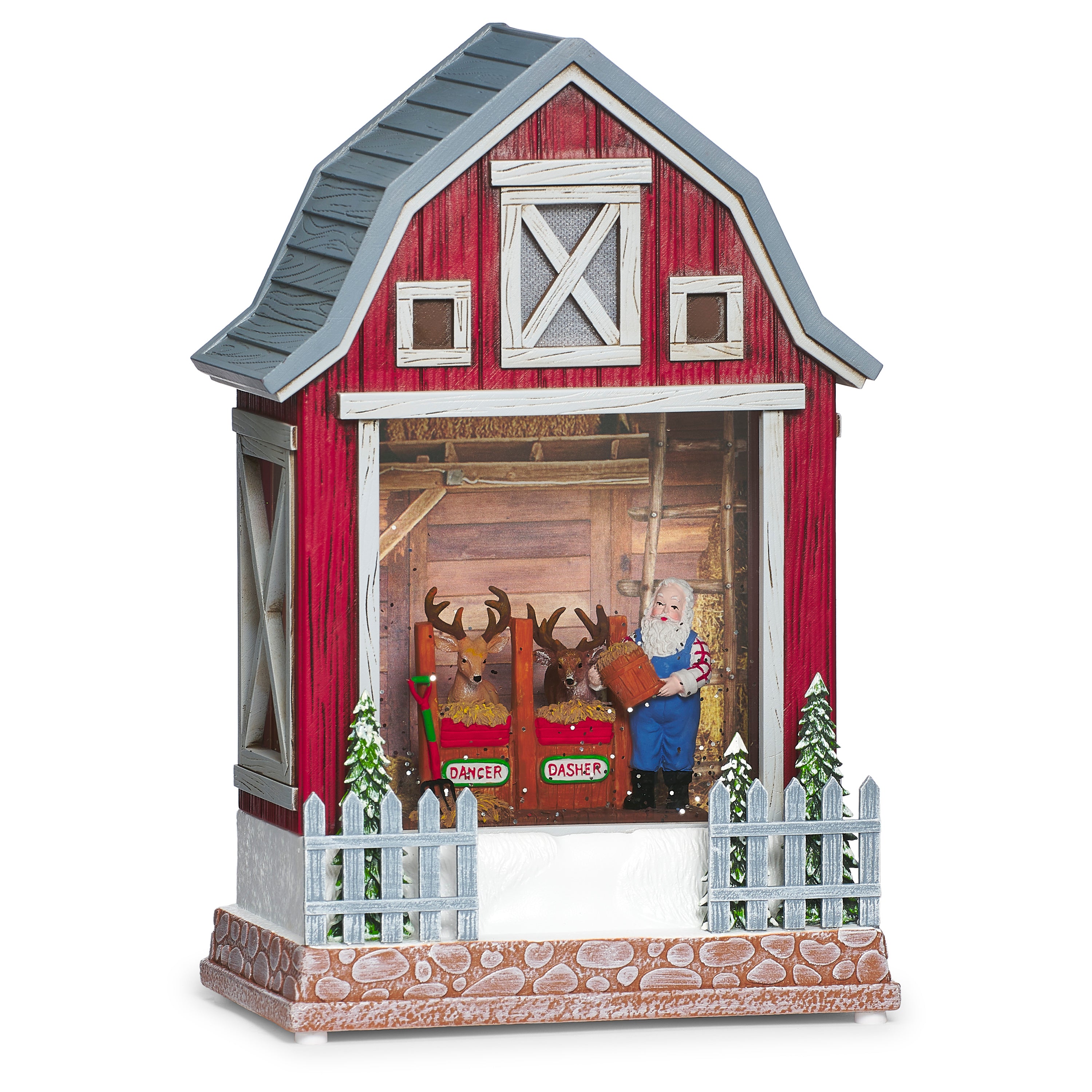 Decorative model of a red barn with a country Santa and reindeer inside on a white background