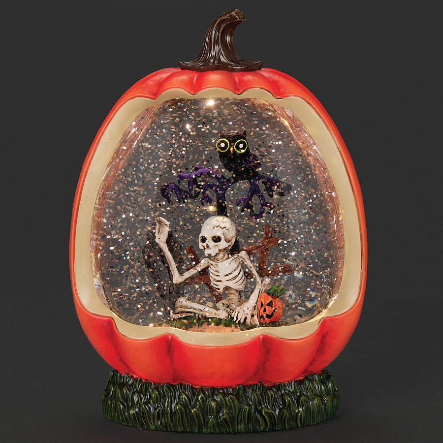 Pumpkin lighted globe with a skeleton and spider inside