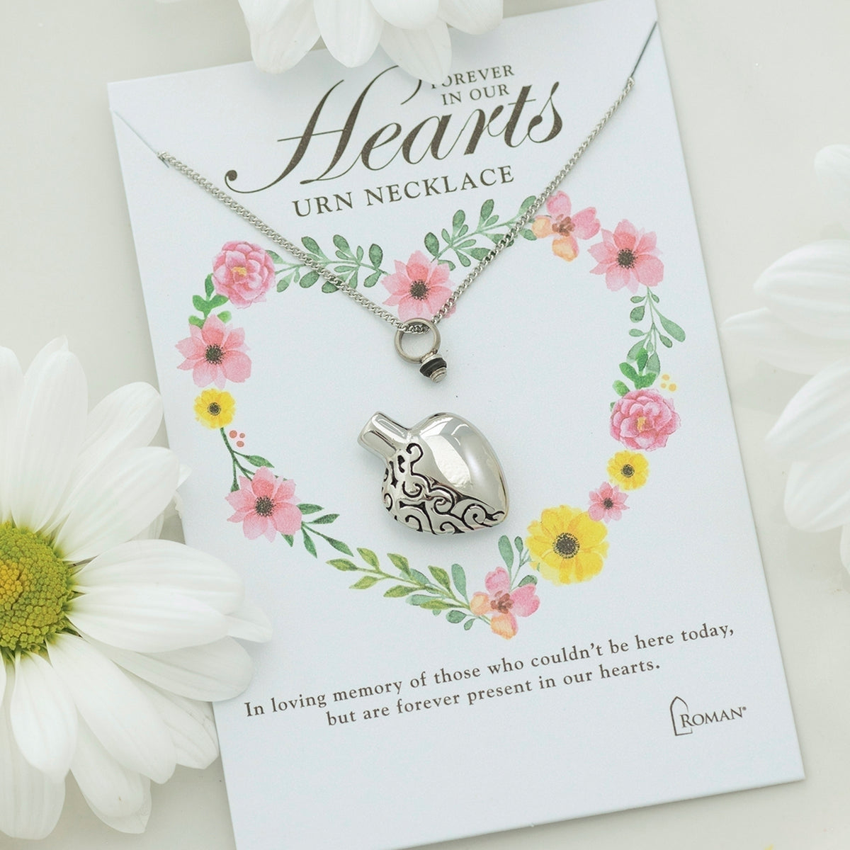 Etched heart memorial urn necklace displayed with Forever in Our Hearts floral gift card