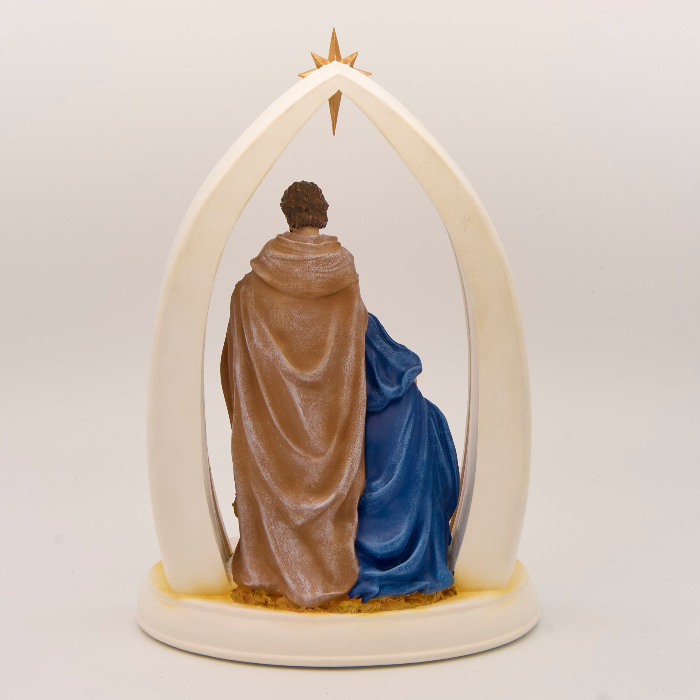 Decorative nativity scene with Mary, Joseph, and baby Jesus in a starlit arch.