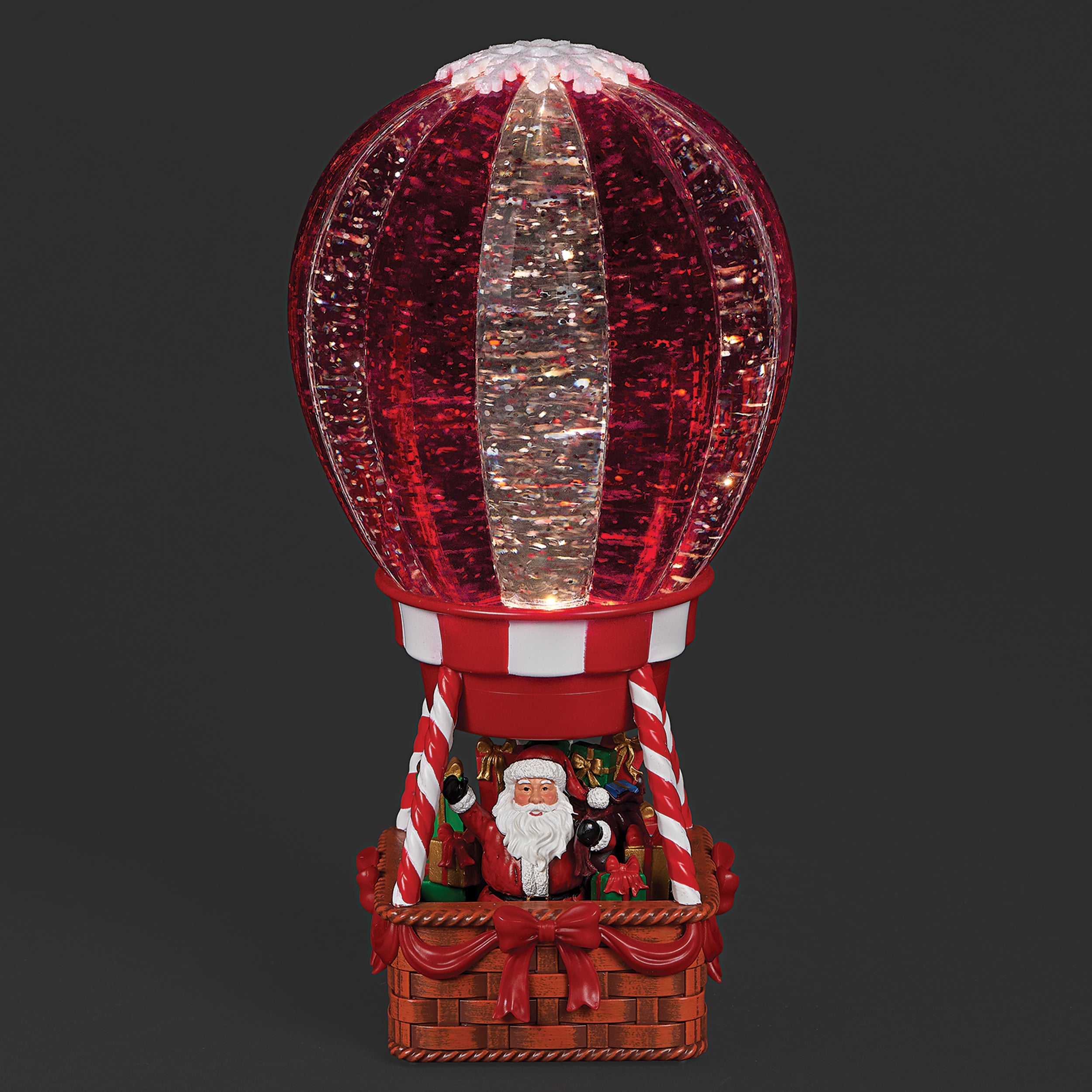Decorative hot air balloon with Santa Claus figure on a dark background