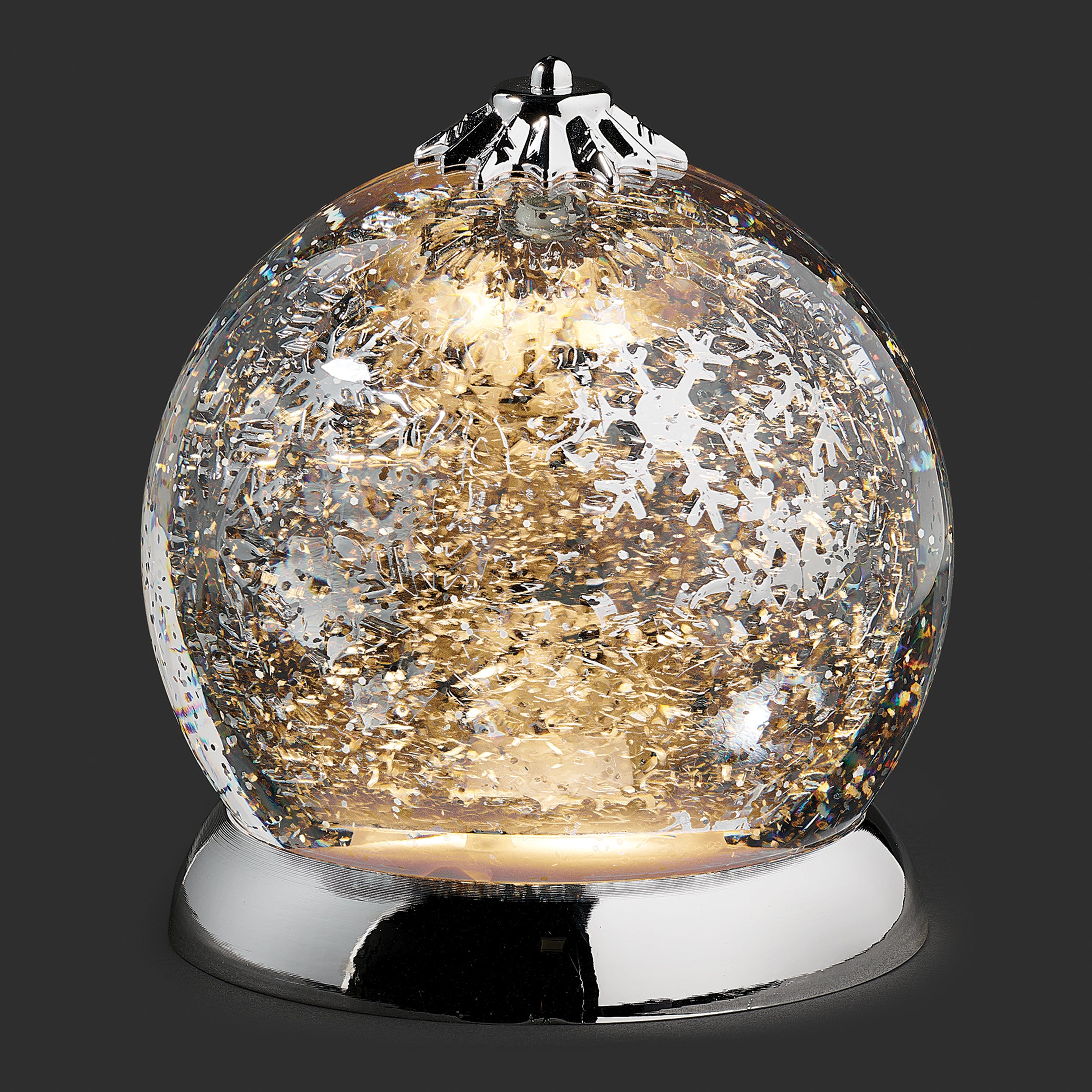 Decorative glass ball with a silver base on a dark background