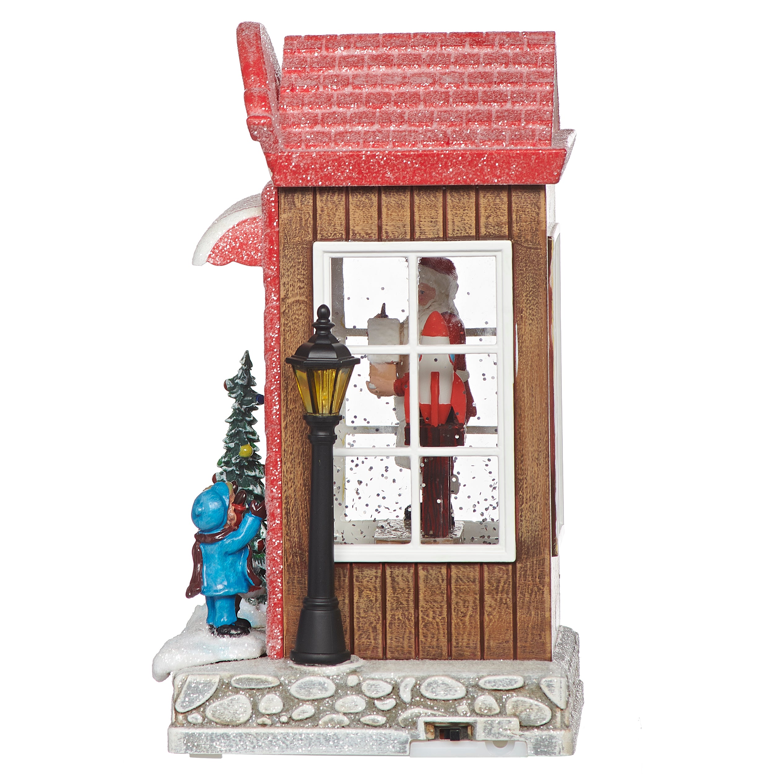 Decorative Christmas scene with a small house, characters, and a lamp post on a white background.