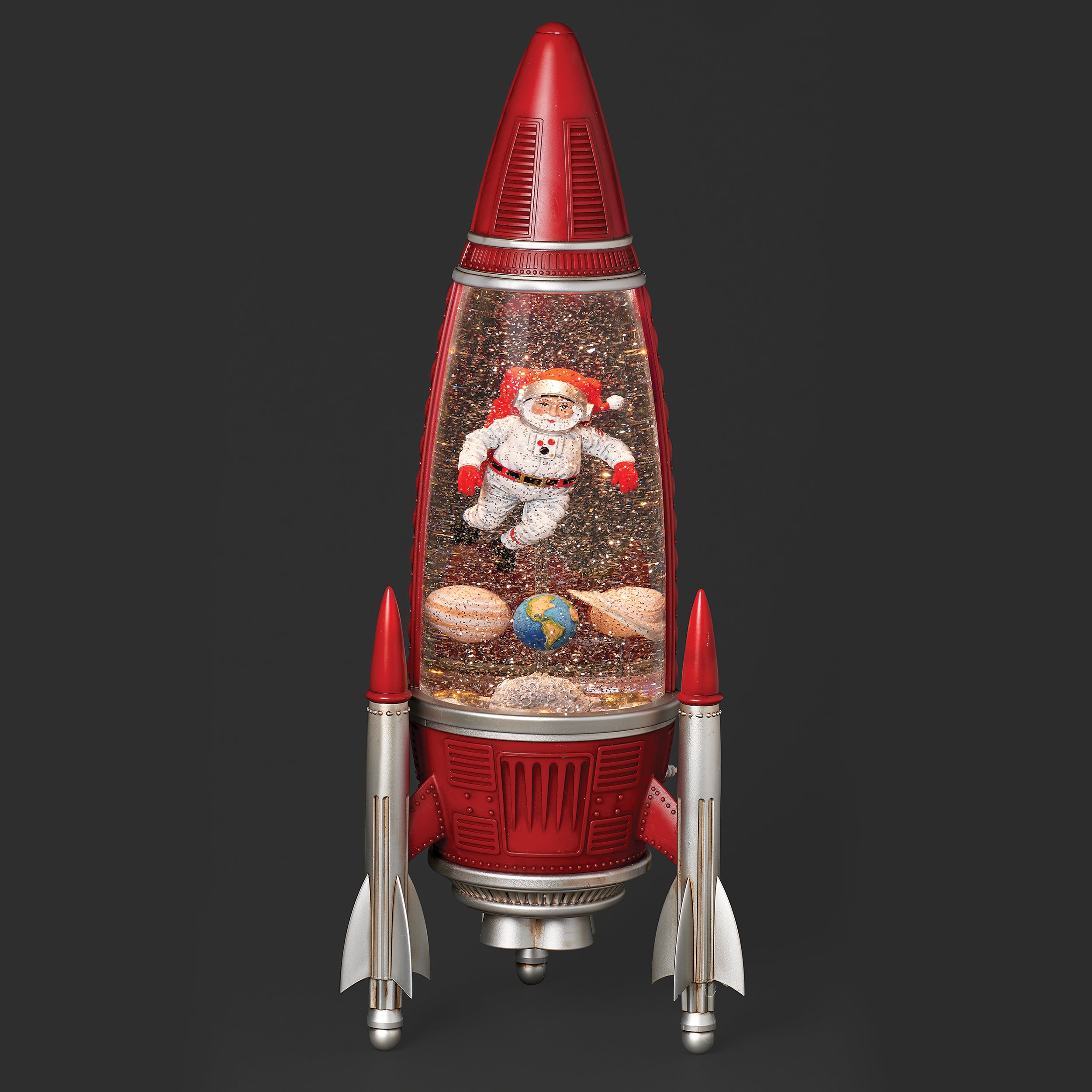 Rocket-shaped lamp with Santa Claus figure and space-themed elements on a dark background