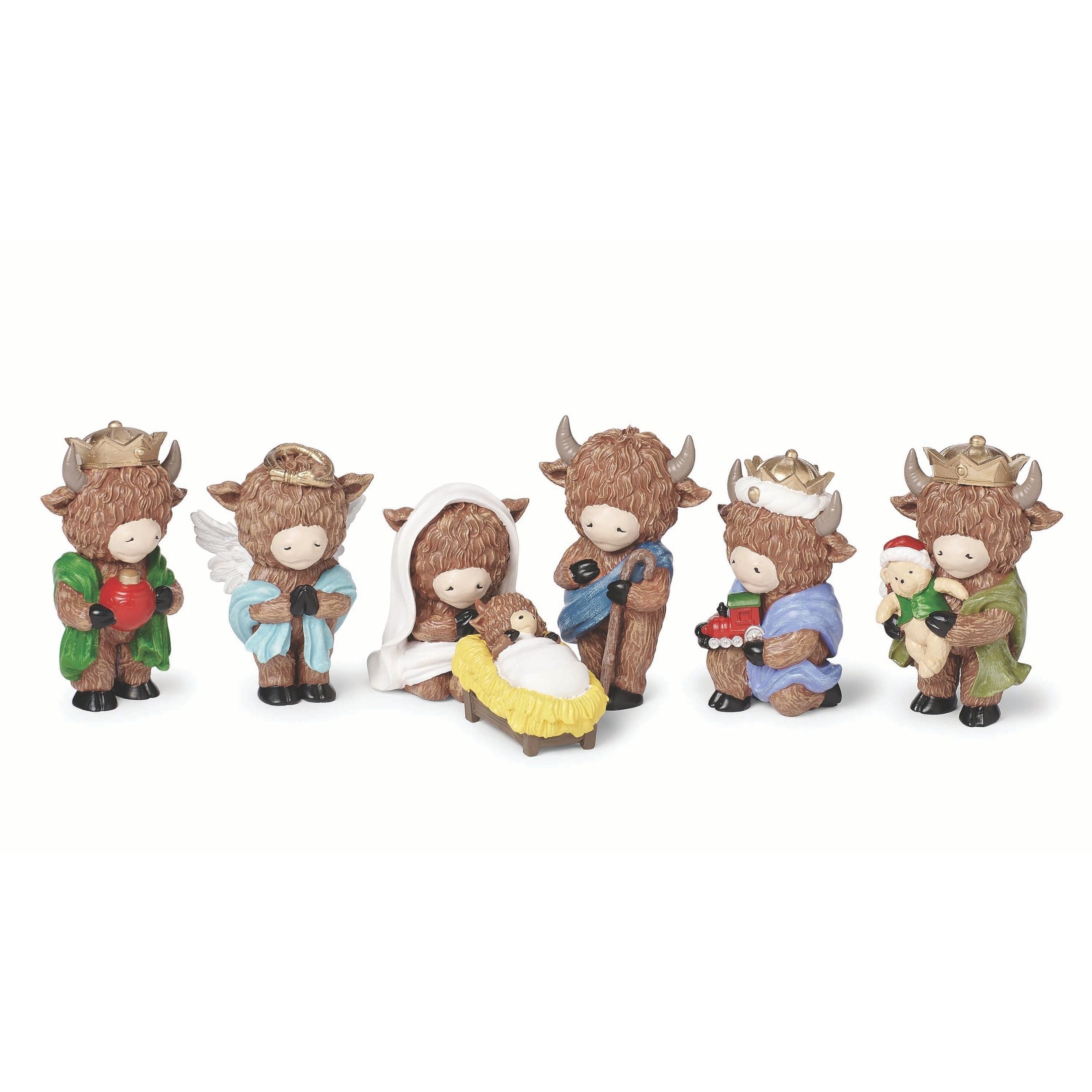 Nativity set of cow figures on a white background