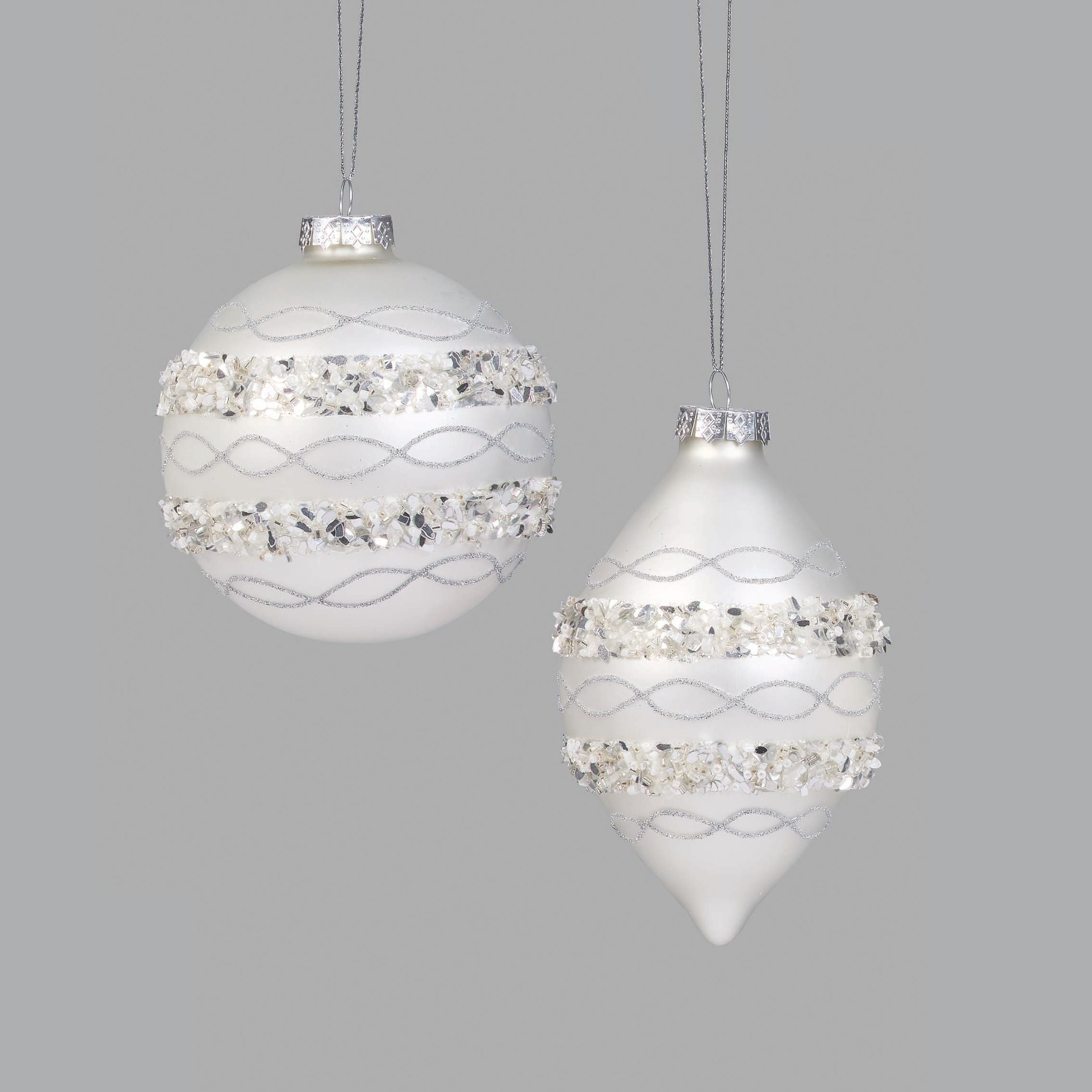 Two decorative Christmas ornaments with crystal embellishments on a light gray background