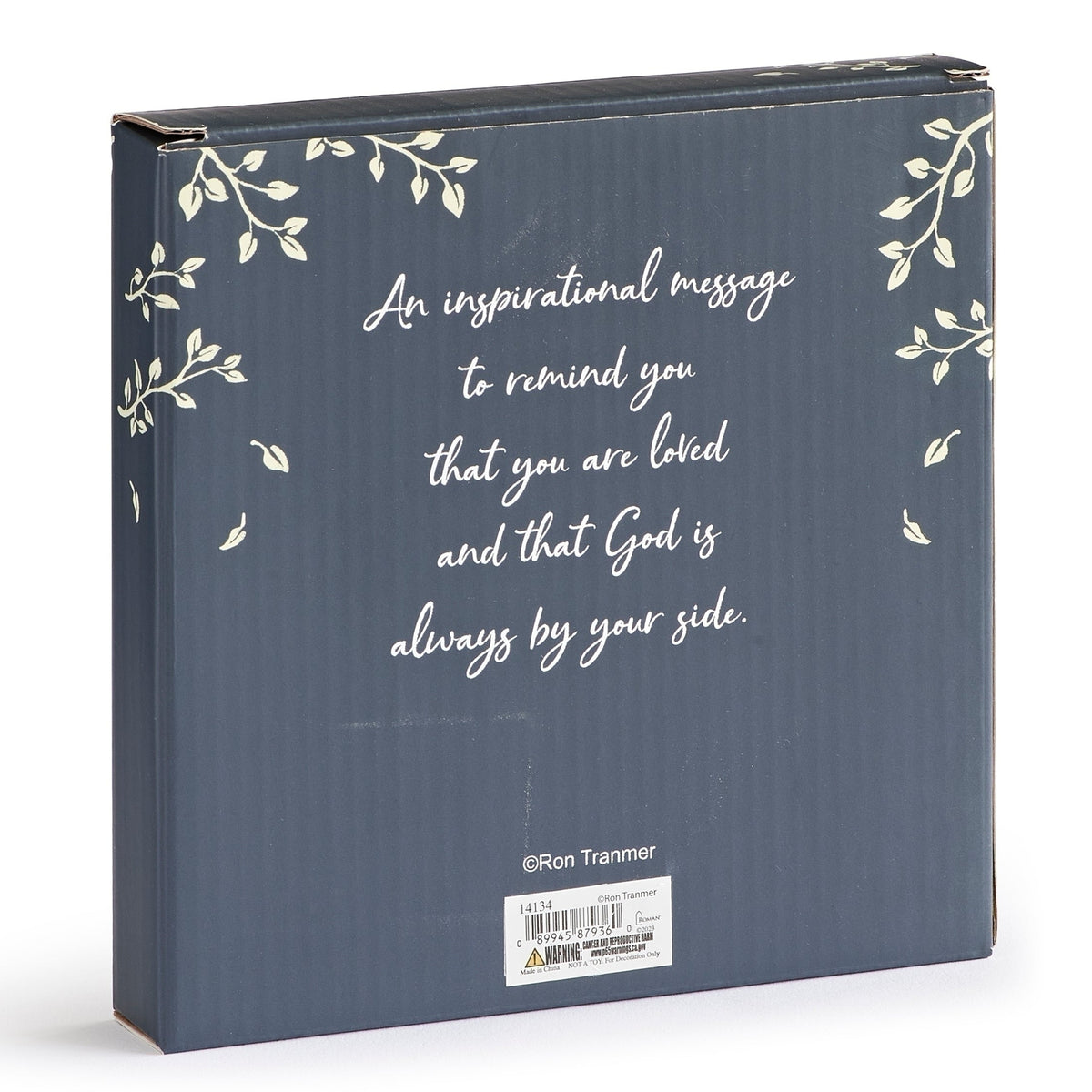 Packaging for Godparent's Baptism Promise Tabletop Plaque featuring a dark background, decorative botanical accents, and printed godparent message