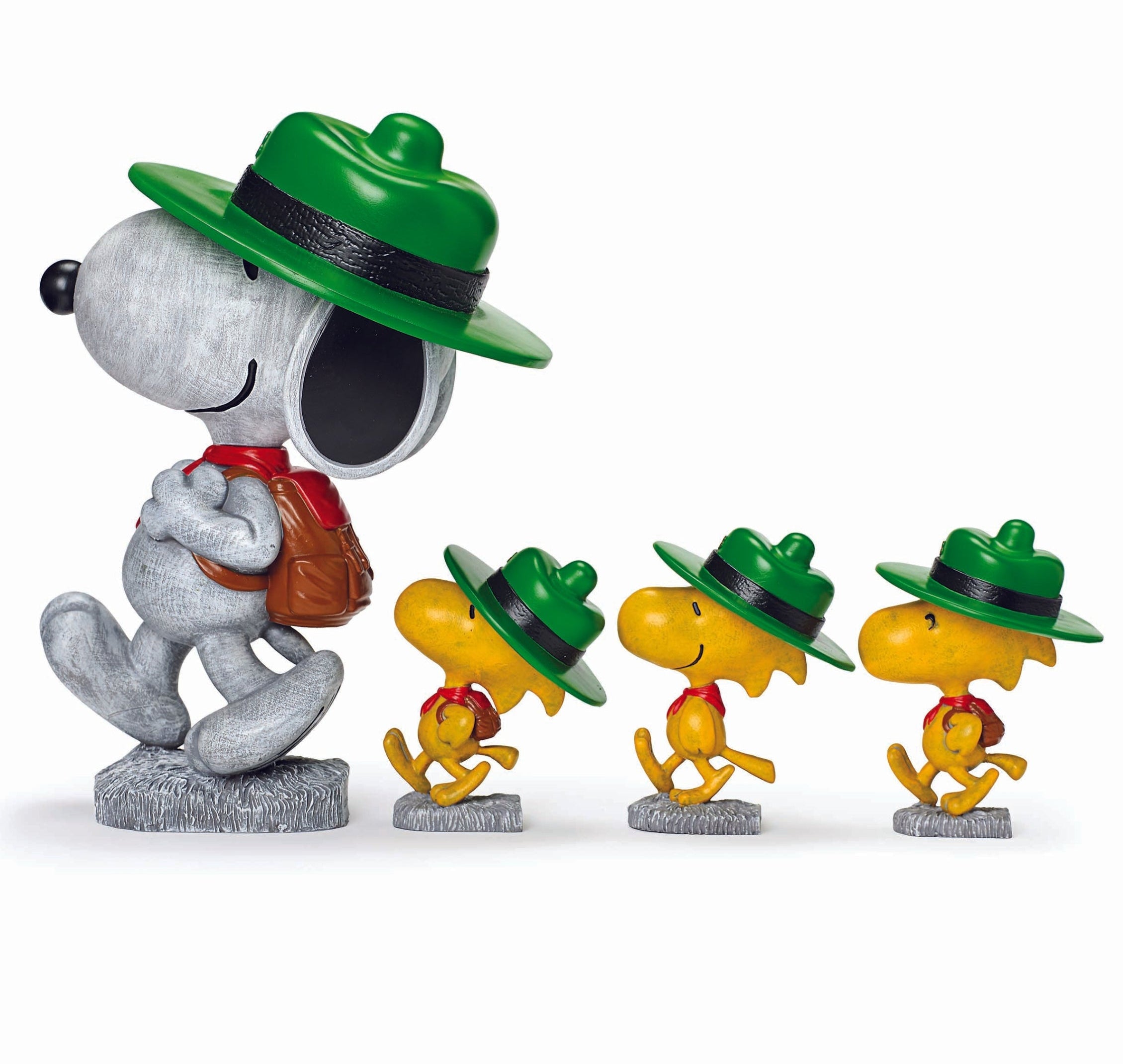 Snoopy figurine with green hat and four smaller figures wearing green hats on a white background