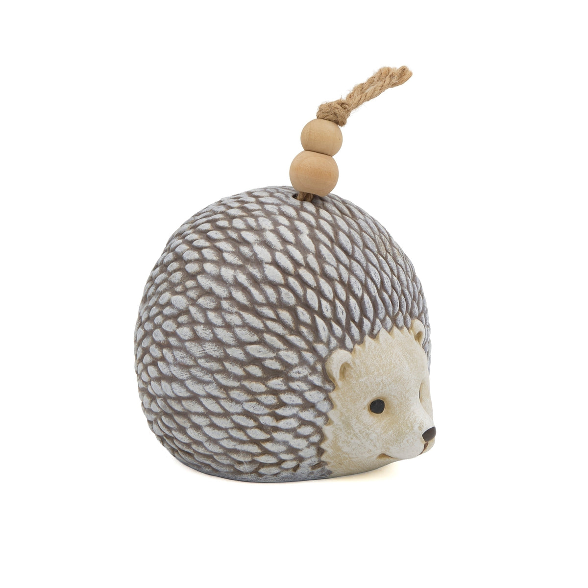 Side view of Pudgy Pals Hedgehog Bell showing the cream hedgehog face, textured quills, and hanging bell