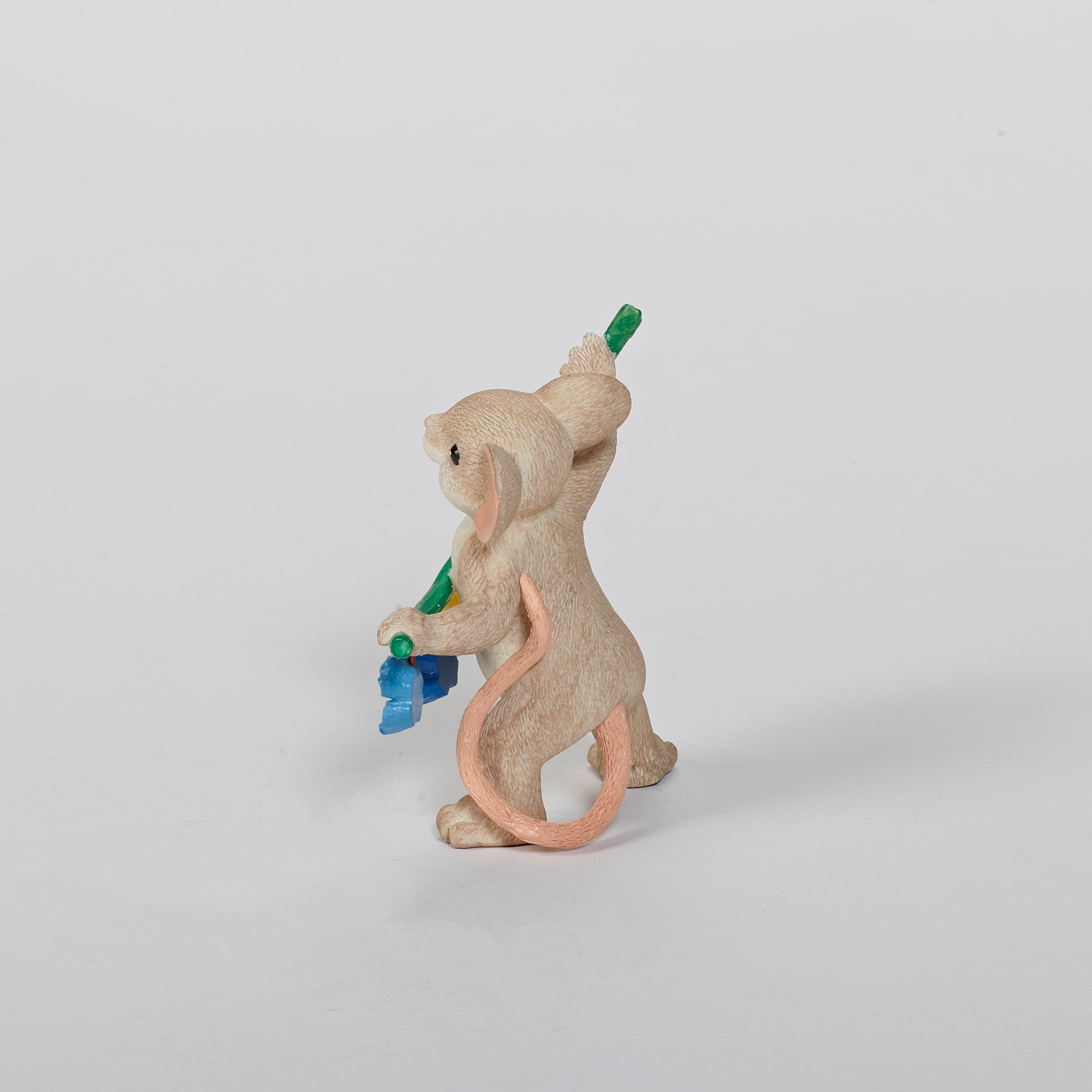 Mouse figurine with a garland spelling 'BLOOM' 