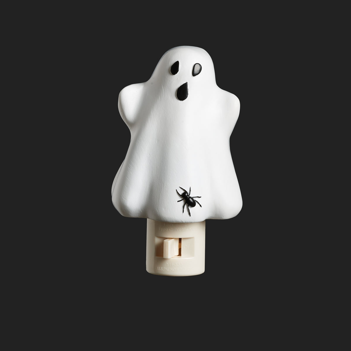 Unlit white ghost night-light with black eyes, an open mouth, and a black spider near the bottom above a white plug-in base.