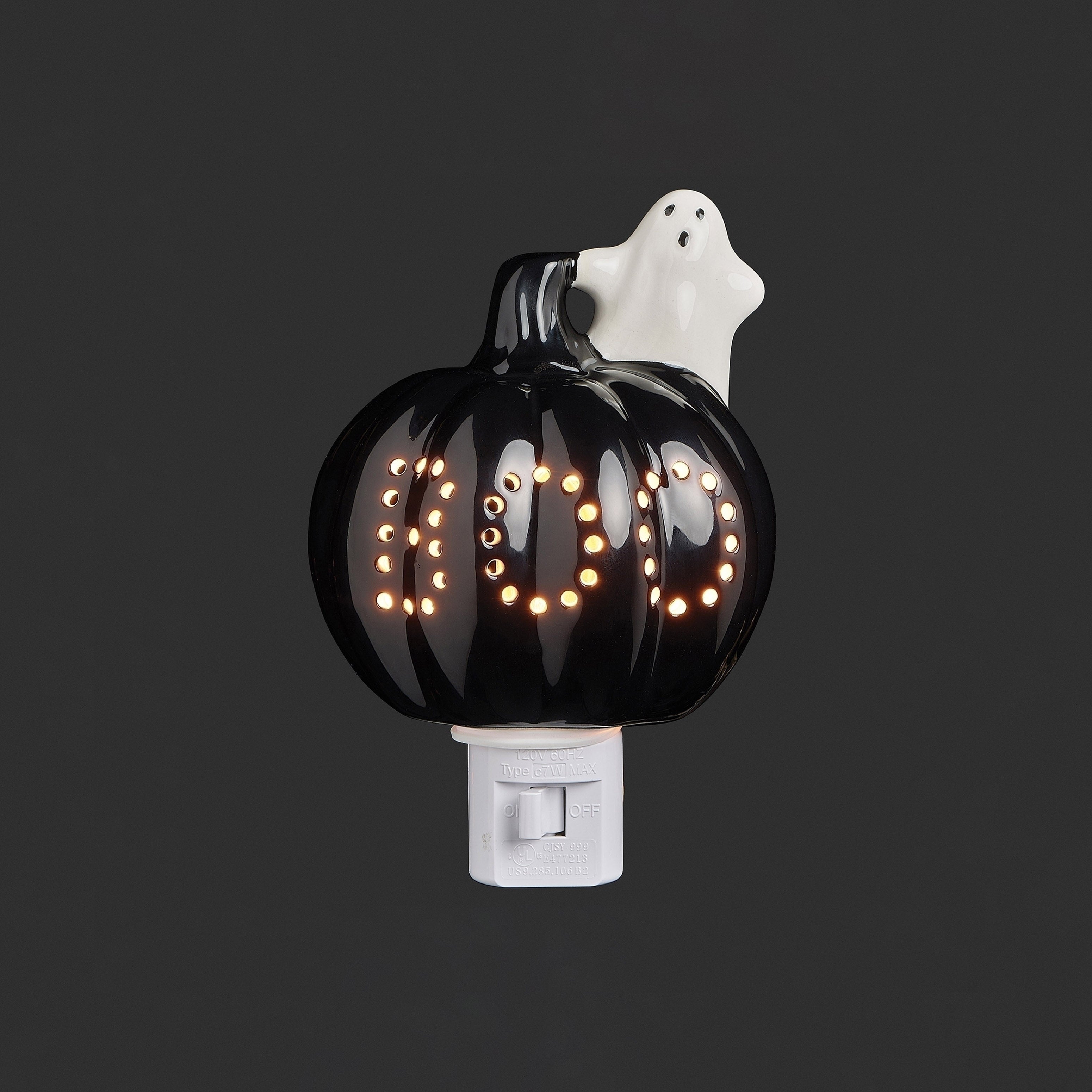 Halloween-themed night light with a black pumpkin and ghost design on a dark background