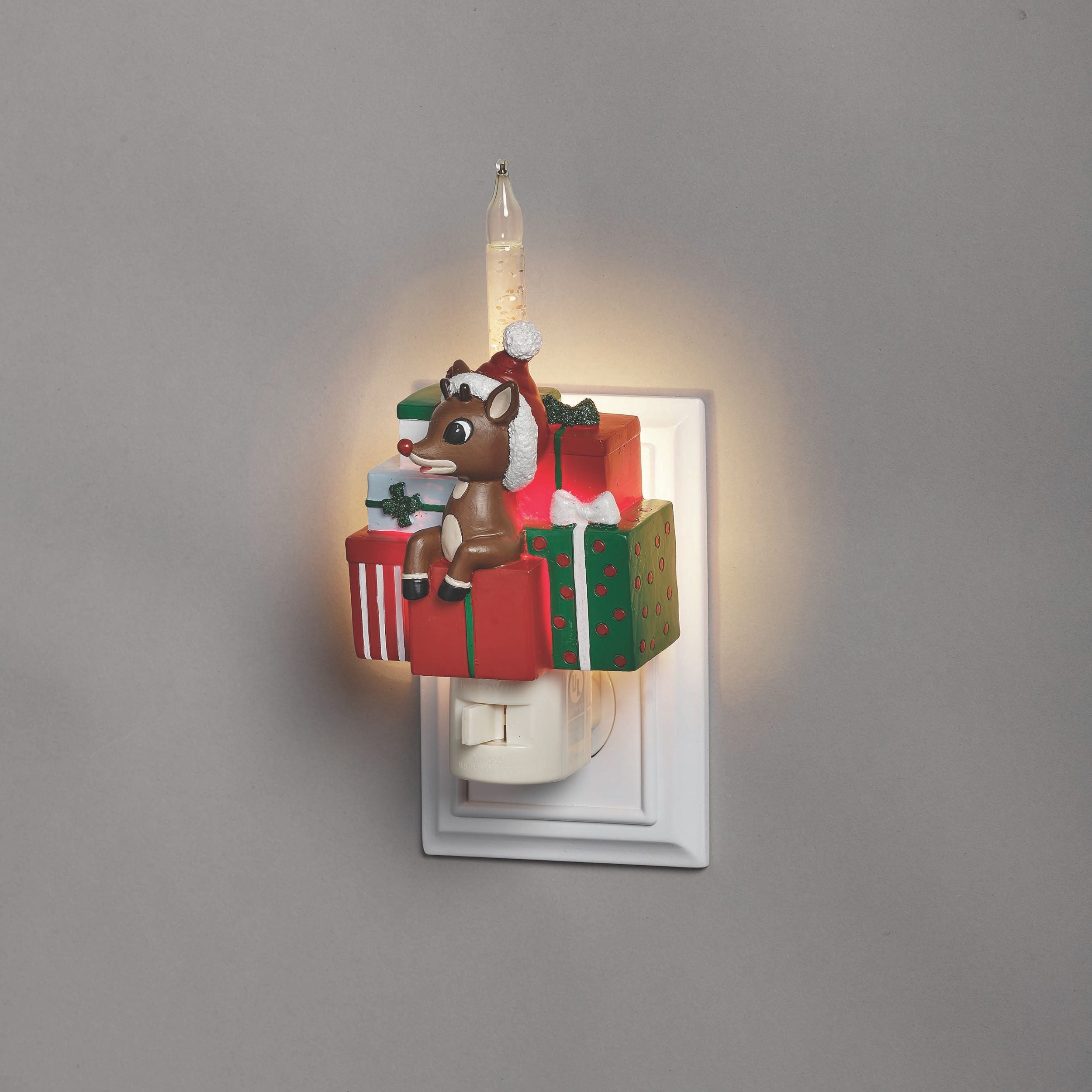 Decorative night light with a reindeer and gift boxes design on a gray background