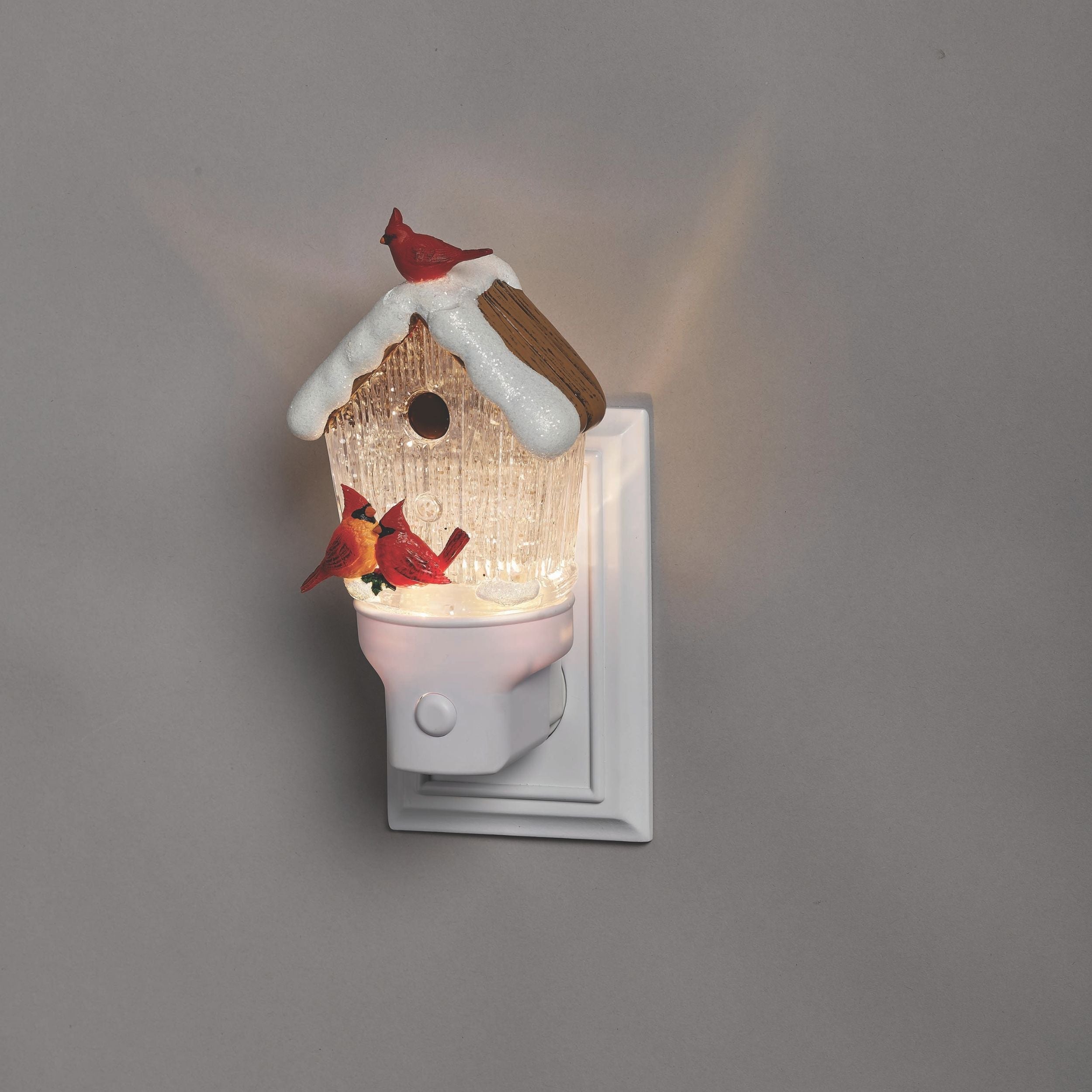 Decorative night light shaped like a birdhouse with a bird design on a gray background