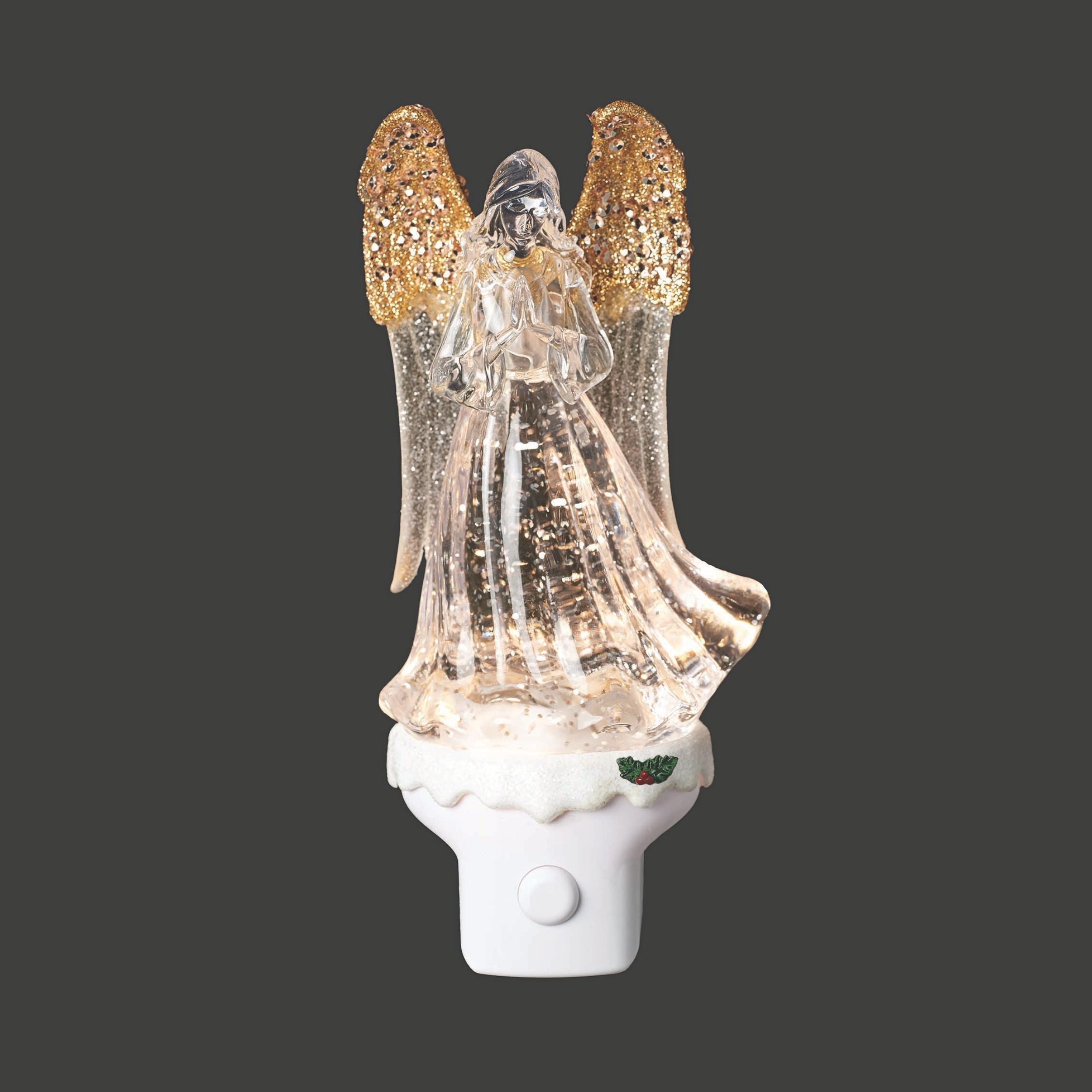 Decorative angel night light with gold wings on a black background