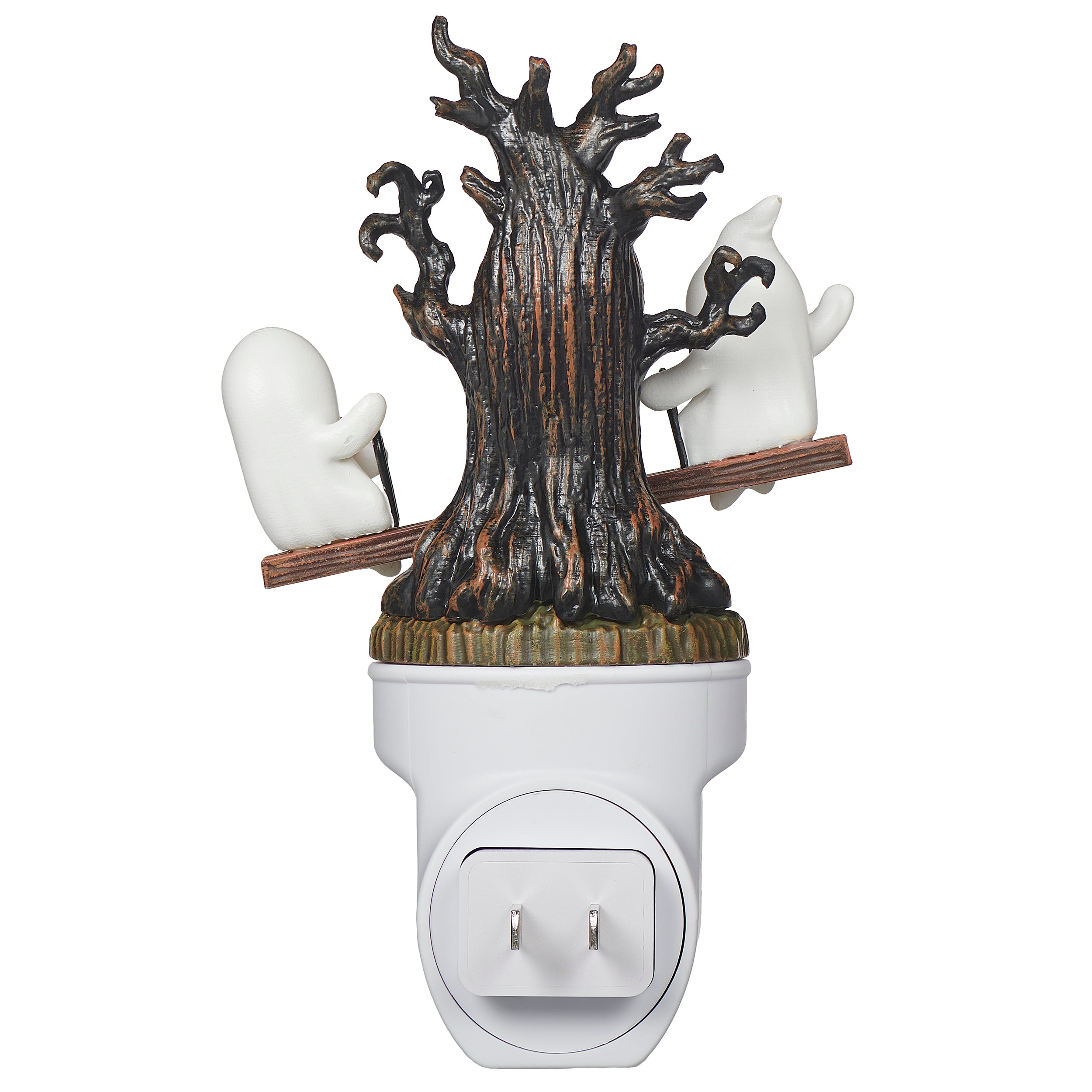 Decorative night light with tree and ghost design on a white background