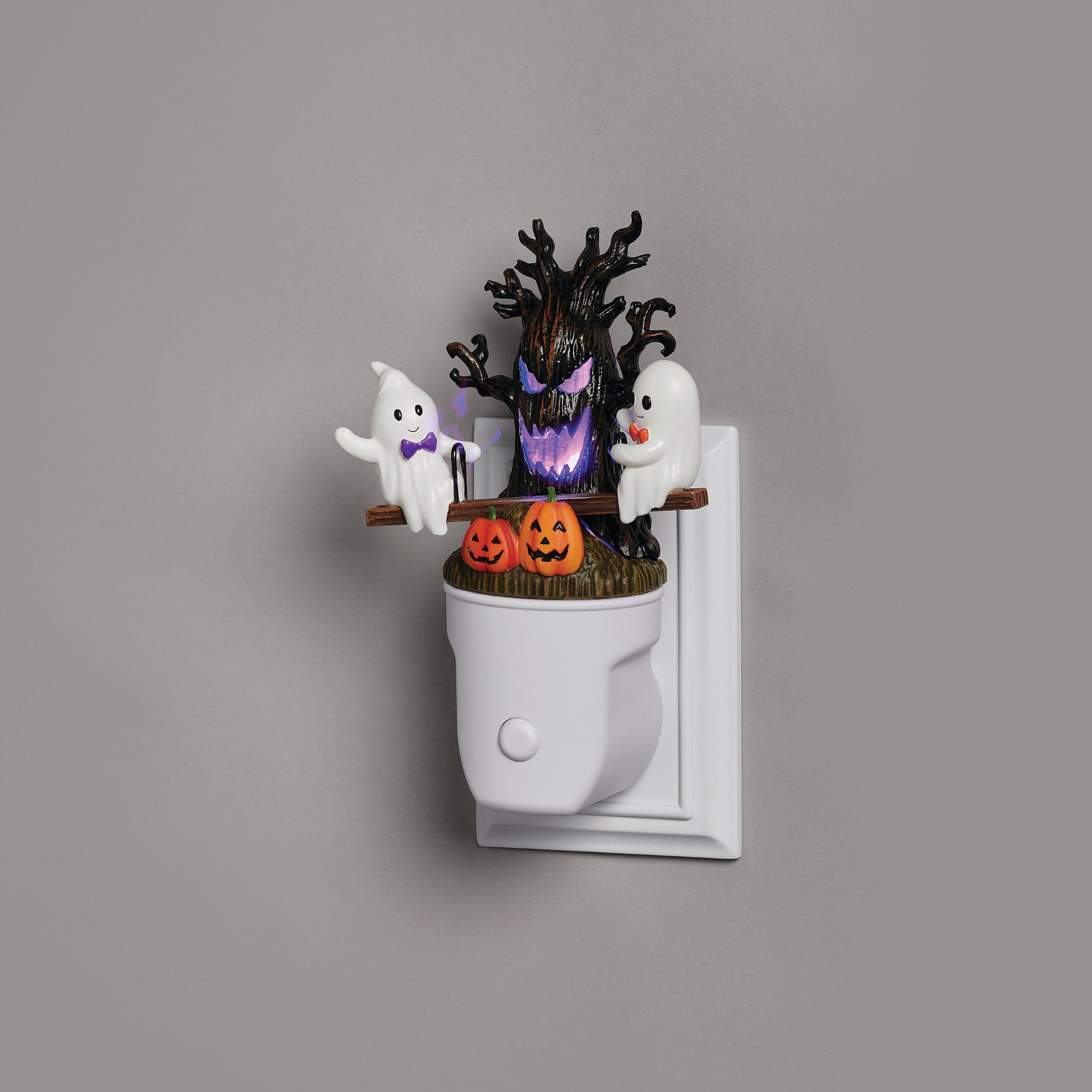 Halloween-themed night light with ghosts, pumpkins, and a tree on a gray background