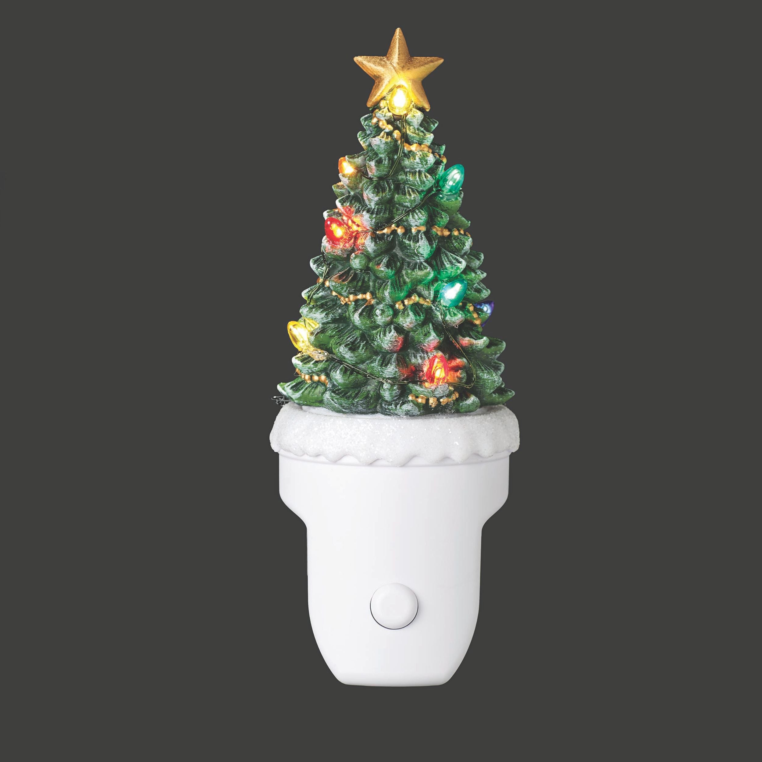 Decorative Christmas tree light fixture on a white base with a dark background