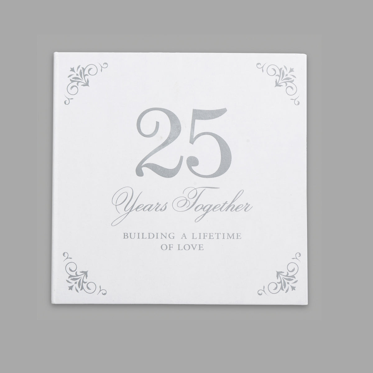 Closed white anniversary gift packaging with a large silver-toned “25” and decorative corner accents.