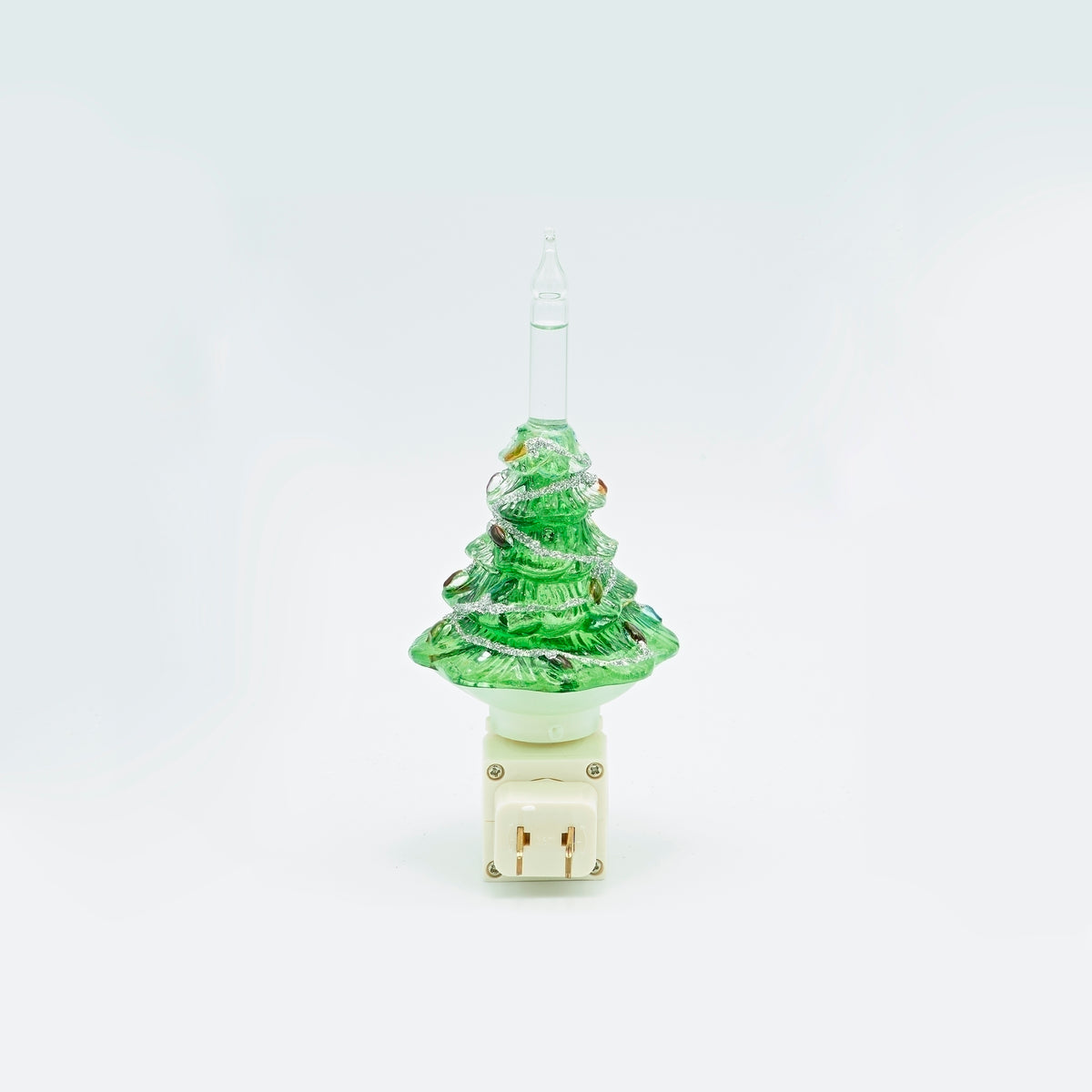 Rear view of Christmas tree bubble night-light showing the plug facing the camera beneath the green tree and clear tube.