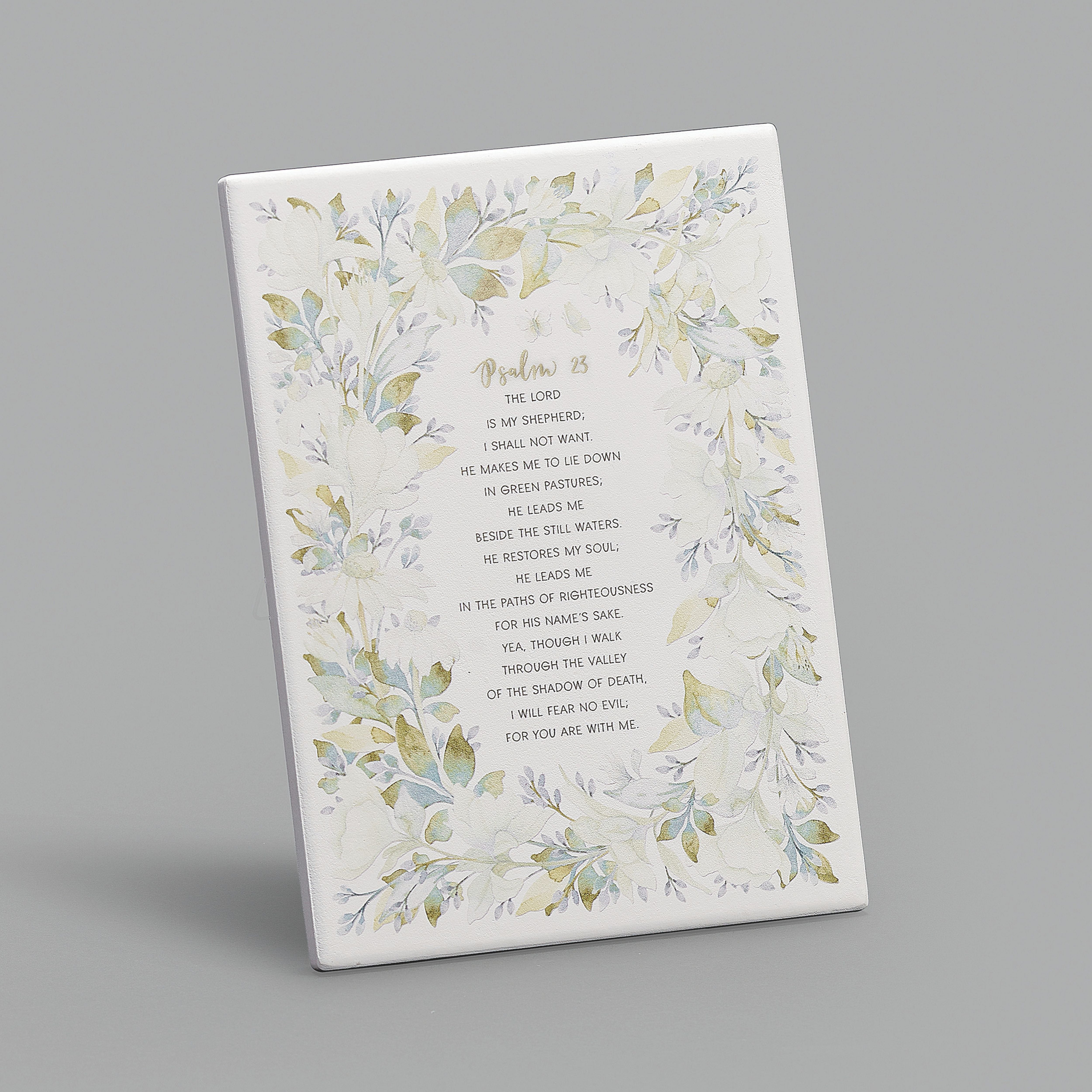 Decorative plaque with floral design and text on a gray background