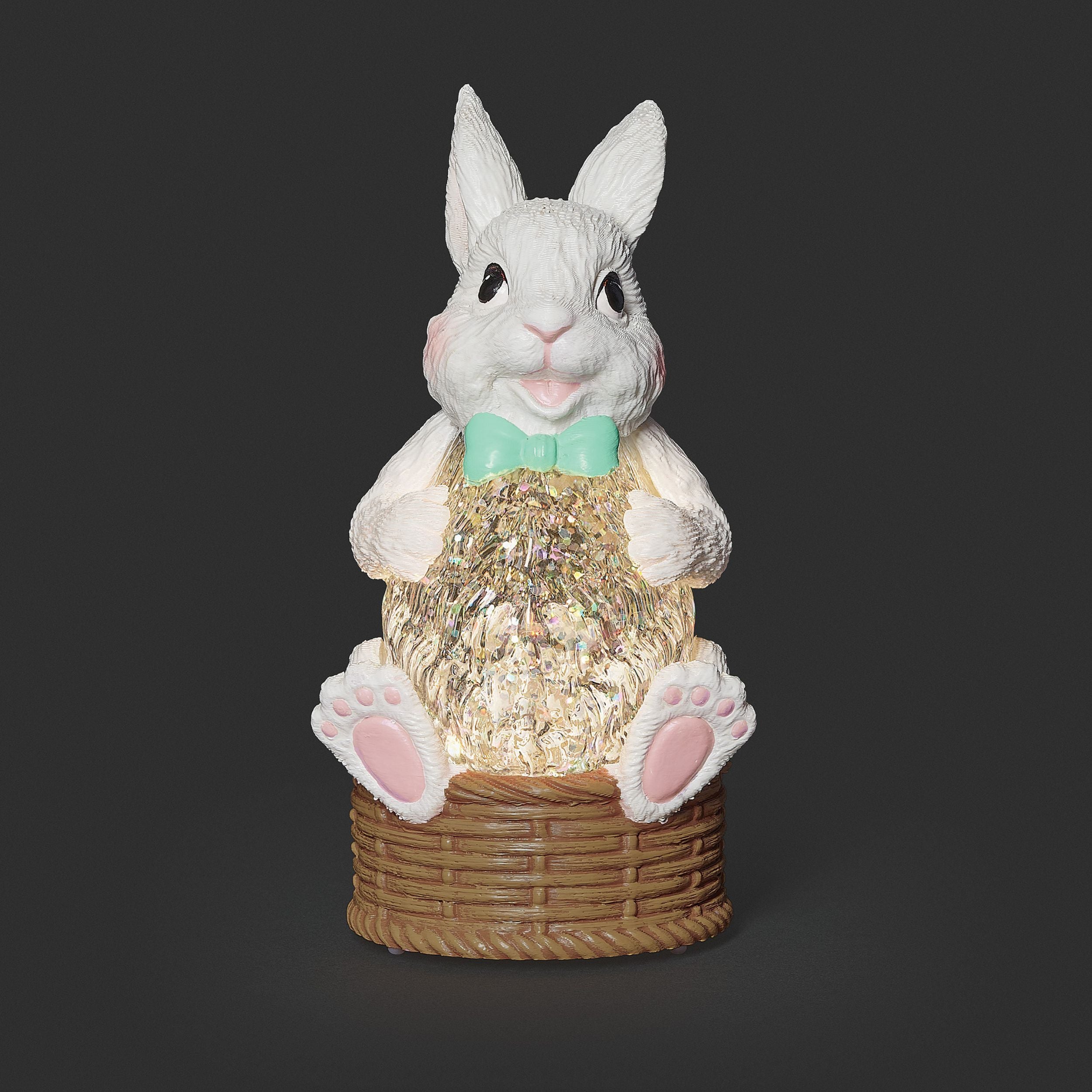 Decorative rabbit figure with a glowing crystal ball on a black background