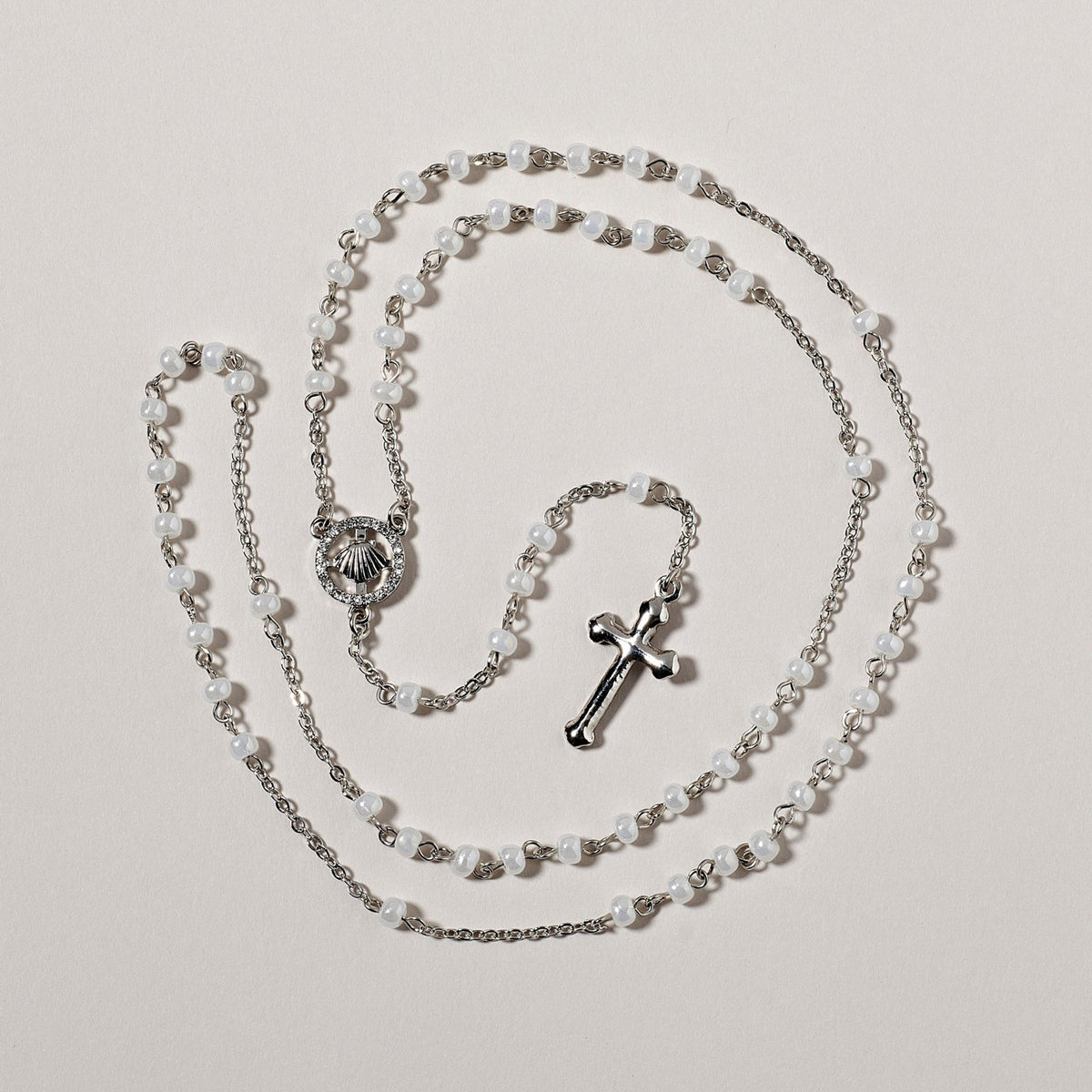 Soft gray baptism rosary arranged in a circle with silver-tone centerpiece and crucifix