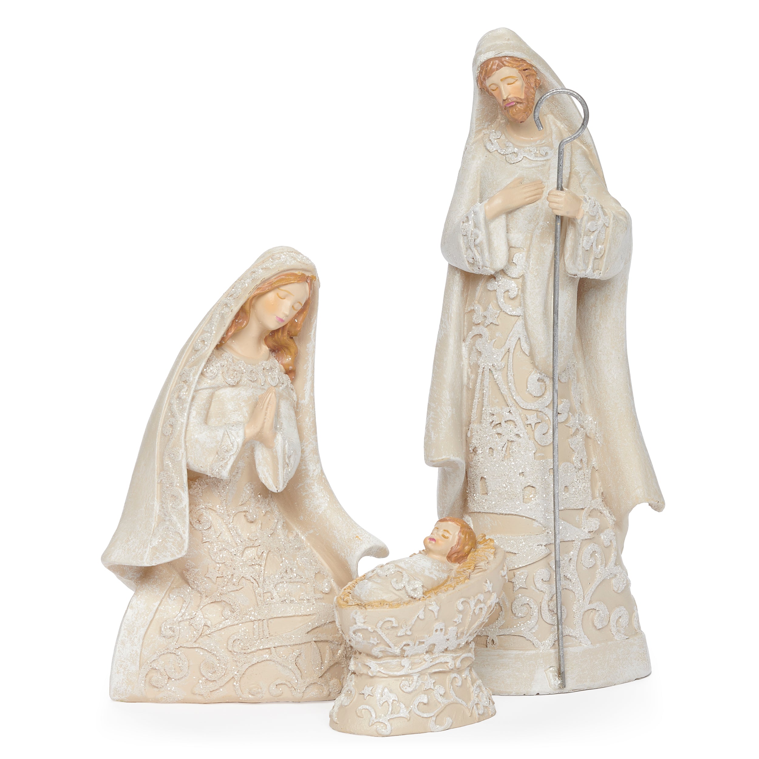 Decorative nativity figurines with intricate designs on a textured surface