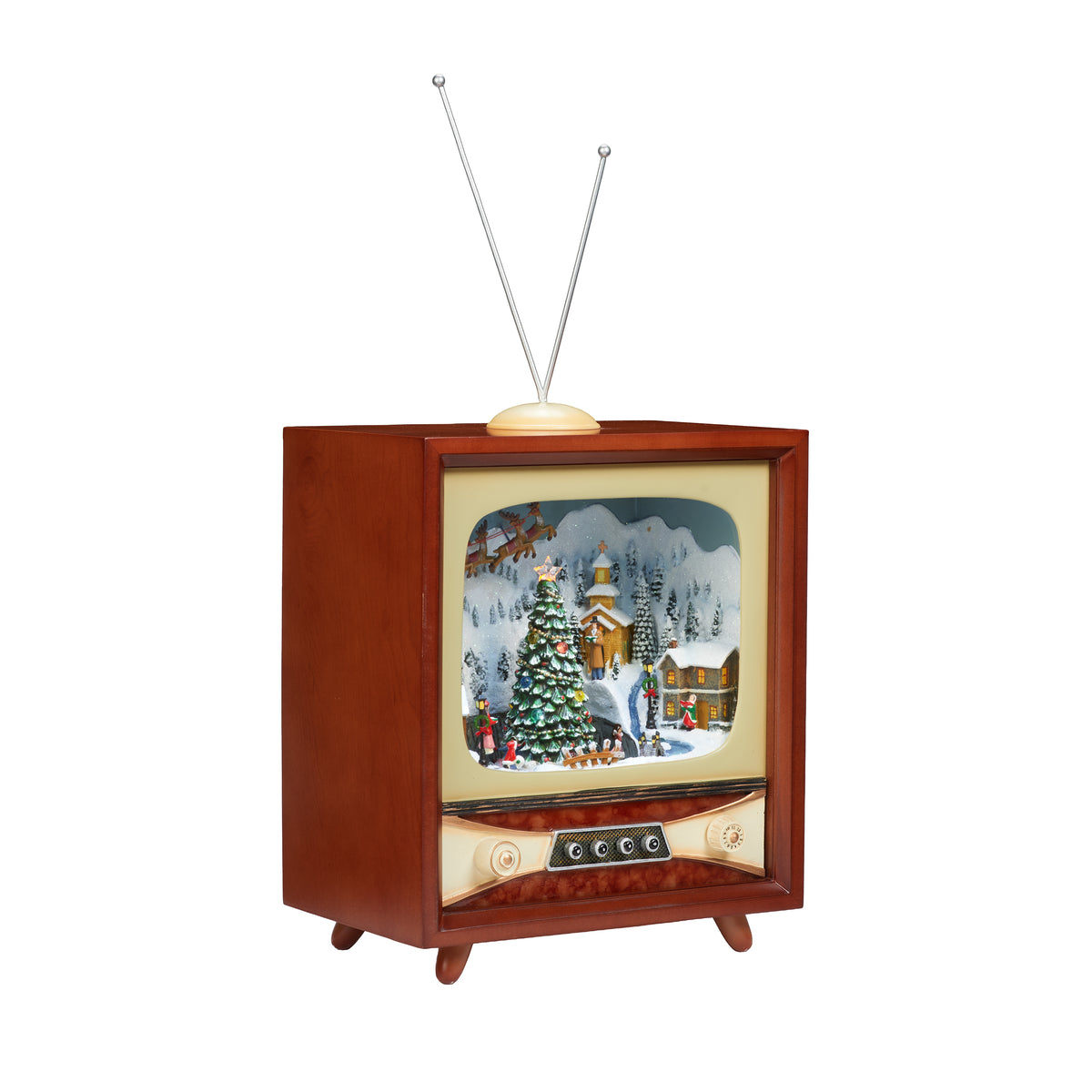 A vintage-style television figurine with a warm brown wood-grain frame, cream-colored faceplate, and silver V-shaped antennas. The screen displays a detailed Christmas diorama with a decorated tree, snowy mountains, and a sleigh scene.