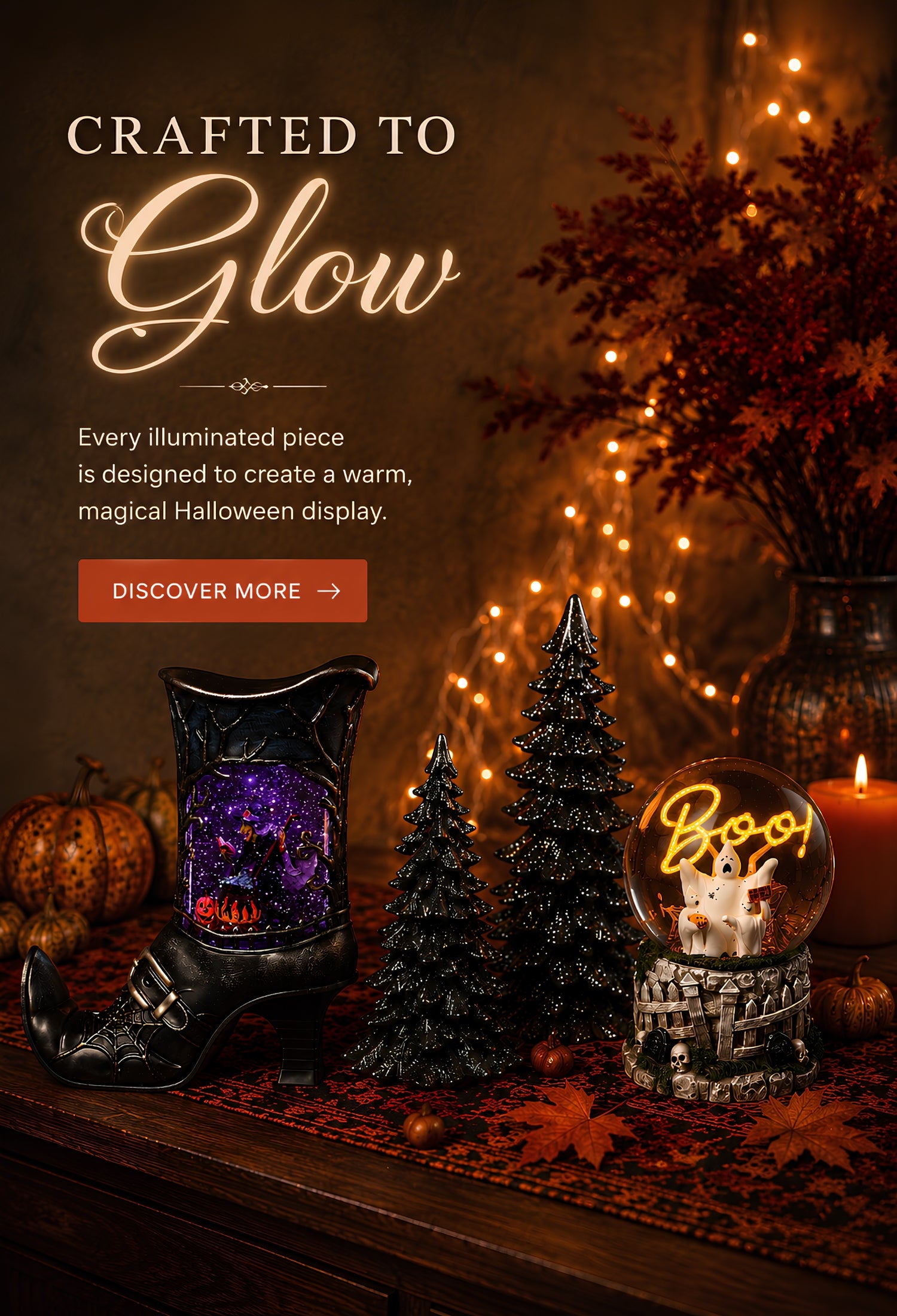 Halloween-themed promotional banner featuring a black witch's boot decorative piece with a glowing purple and orange interior, displayed beside a glowing 'Boo!' glitterdome, small black Christmas trees, pumpkins, and warm string lights. Large text reads 'Crafted to Glow' with a 'Discover More' button.