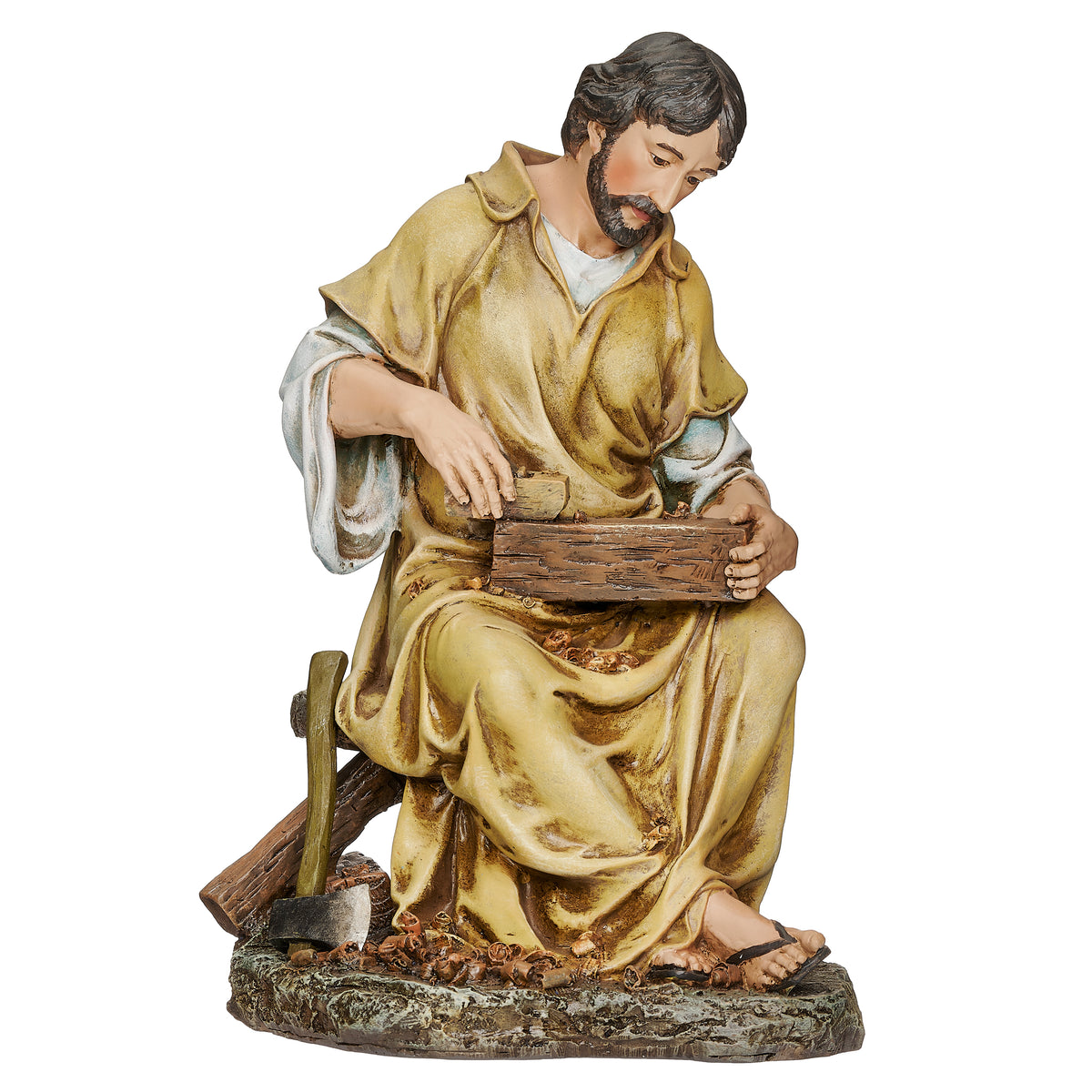 Joseph's Studio St. Joseph the Carpenter Figure featuring St. Joseph seated at work with a chisel and piece of wood in warm gold and earth-tone robes