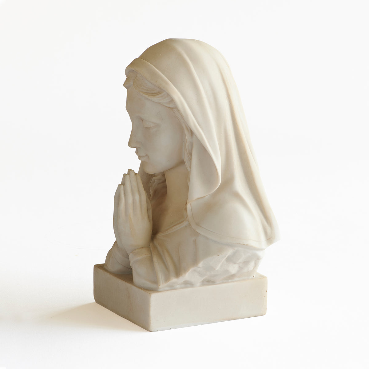 Front angled view of Ivory Madonna Bust showing the prayerful pose, sculpted veil, and ivory resin finish