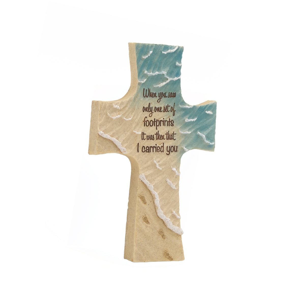 Angled front view of Footprints cross showing raised ocean waves, textured sand, and the central inscription.