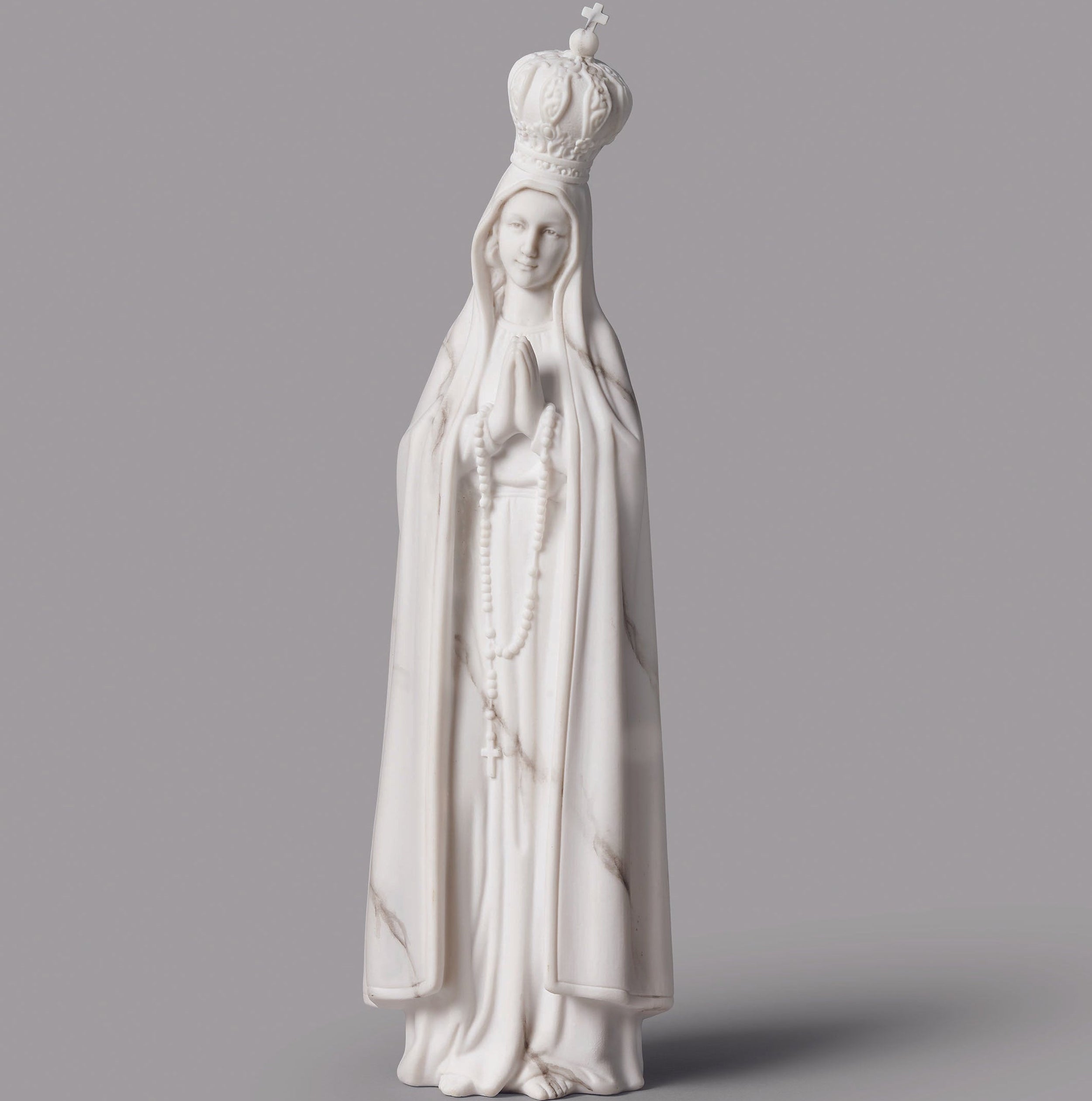 White marble statue of a religious figure with a gray background