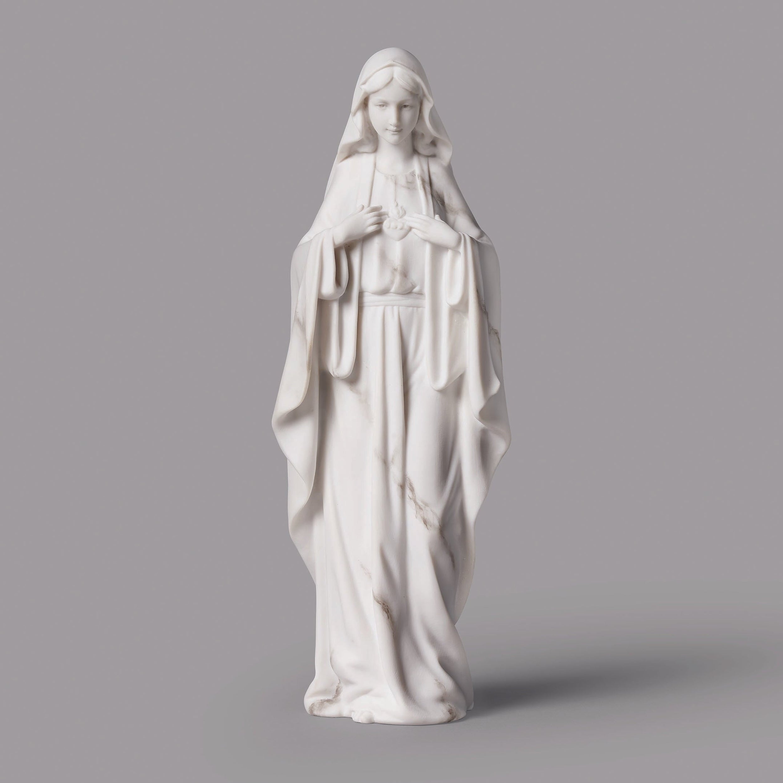 White statue of a religious figure on a gray background
