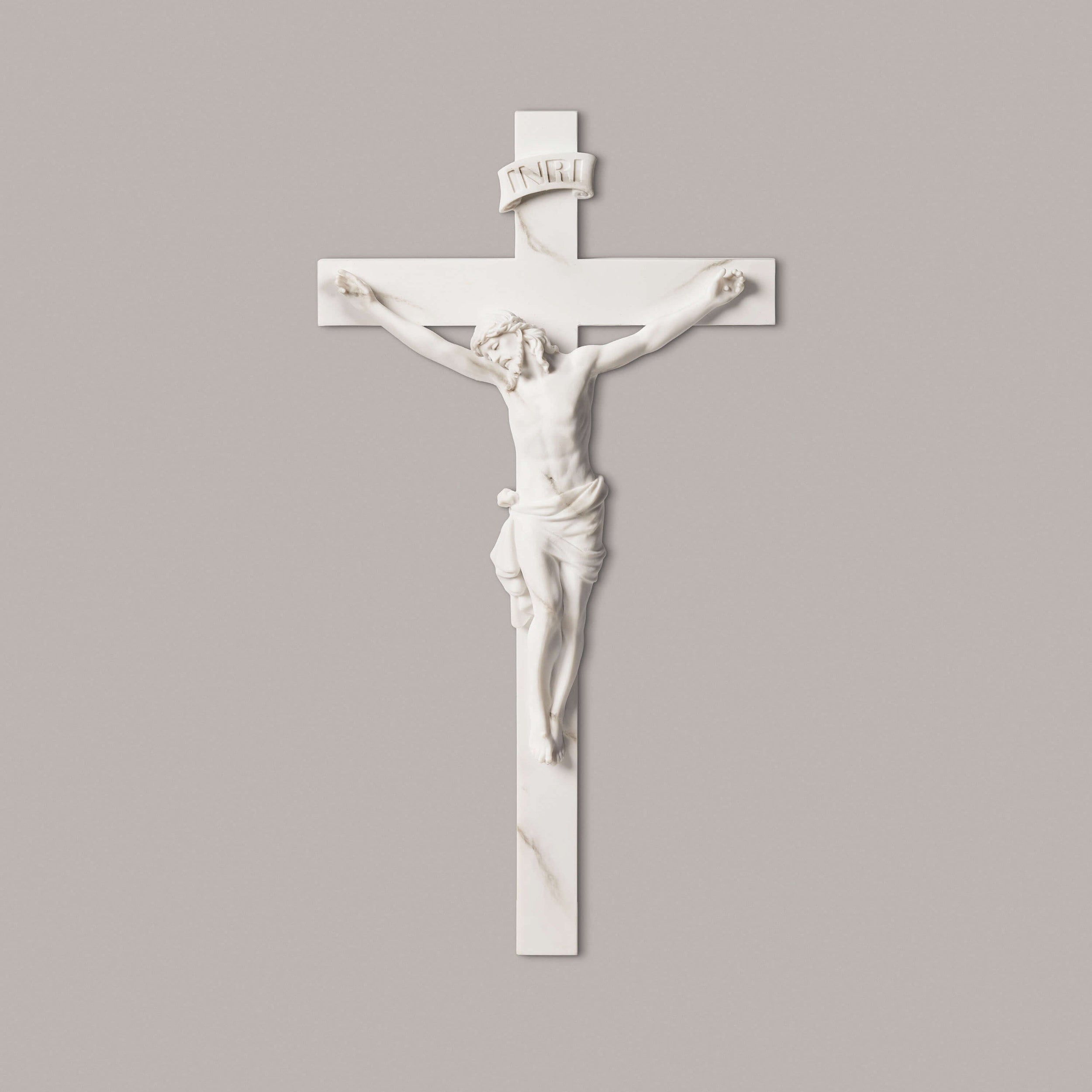 White crucifix with Jesus Christ figure on a gray background