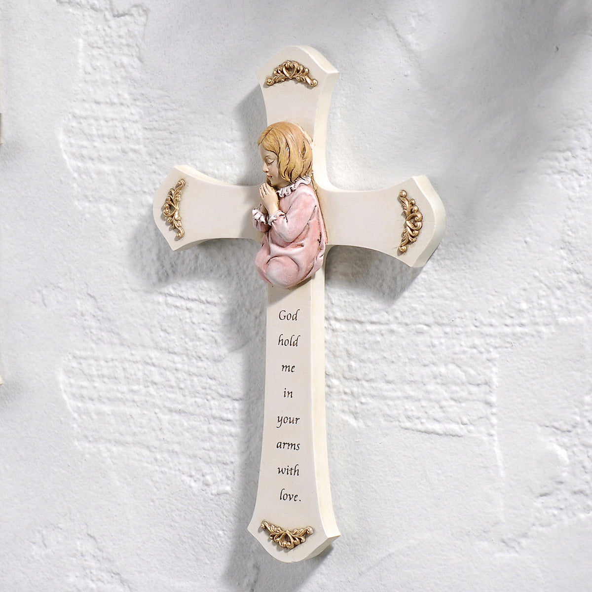 Joseph's Studio Praying Child Wall Cross with pink-clad child displayed on a wall