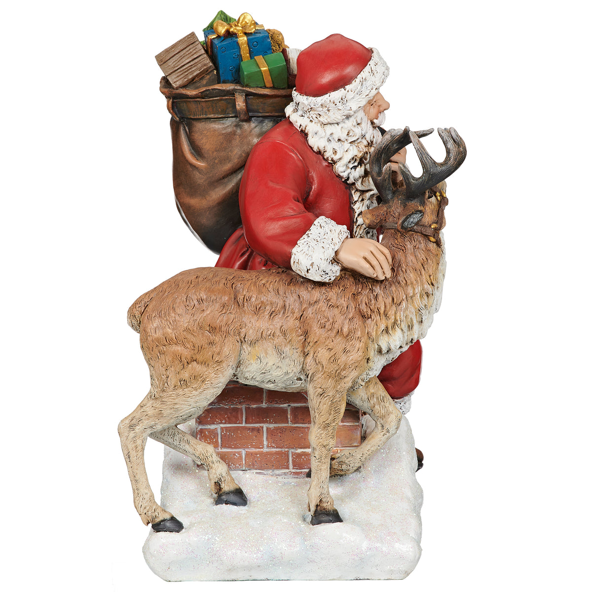 Side view of Santa with deer and sack of Christmas gifts on snowy rooftop