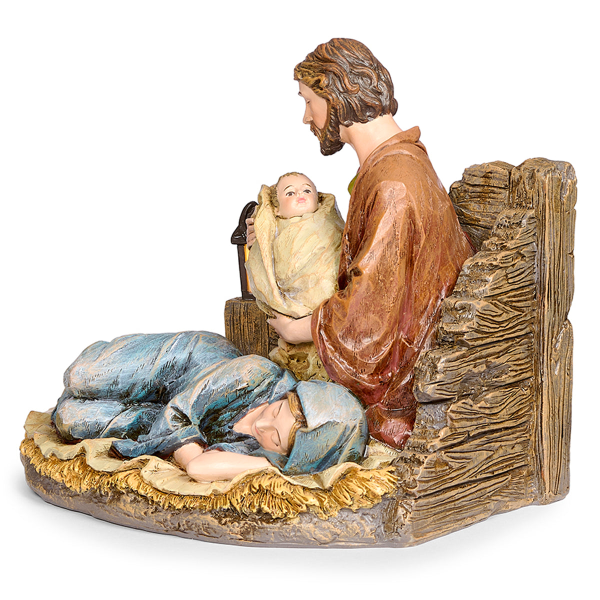 Front angled view of Joseph's Studio Lighted Sleeping Mary Holy Family Figure showing Joseph holding baby Jesus beside the reclining Mary and rustic wood-look backdrop