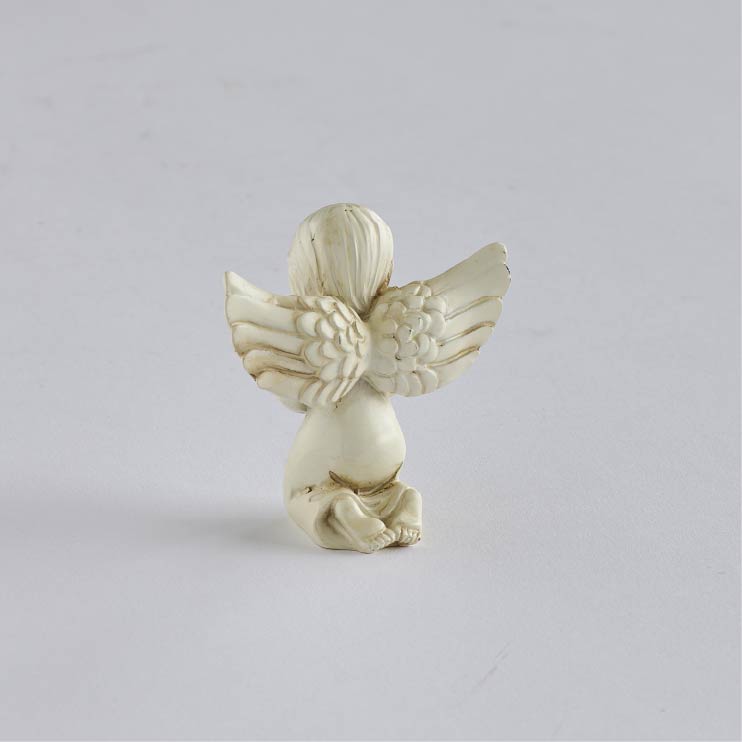 Rear view of kneeling angel showing carved hair, layered wing feathers, and the folds of its gown.