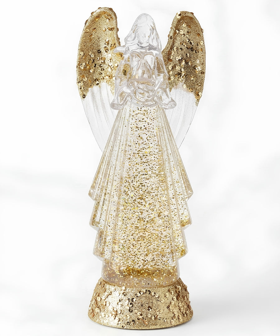 A decorative angel figurine with clear wings and a glittery gold dress, standing on a textured gold base against a white background.