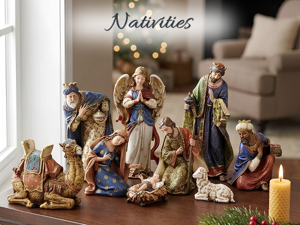 A Nativity set of figurines displayed on a wooden table in a cozy living room setting. The set includes Mary, Joseph, baby Jesus, the three wise men, an angel, a camel, a sheep, and a candle.