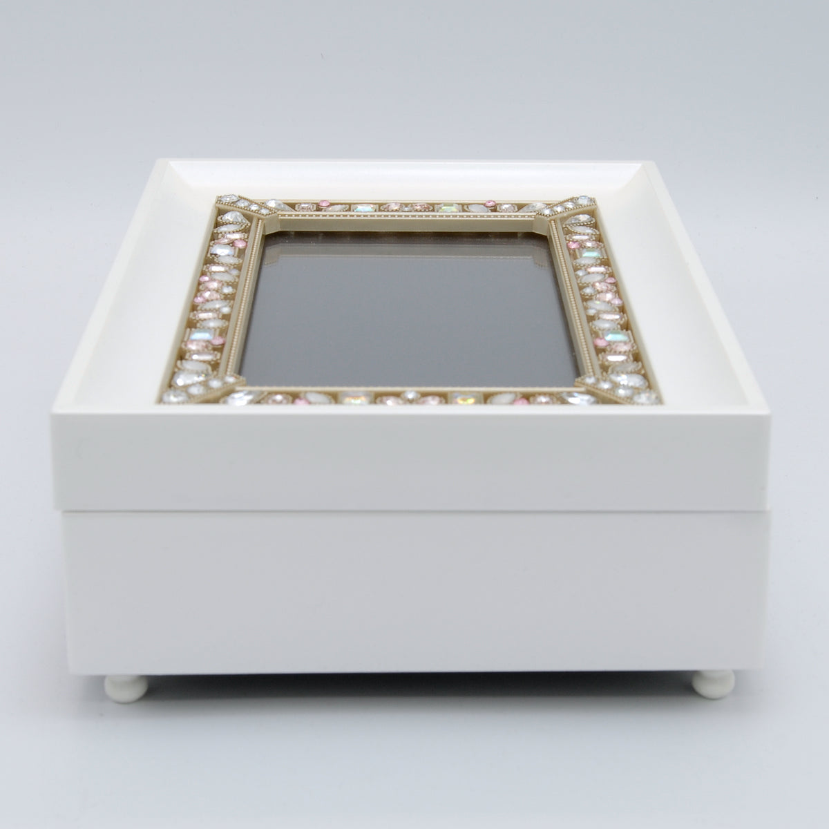 Top angled view of Day of Your Baptism music box showing the white keepsake box, framed glass lid, and jeweled border